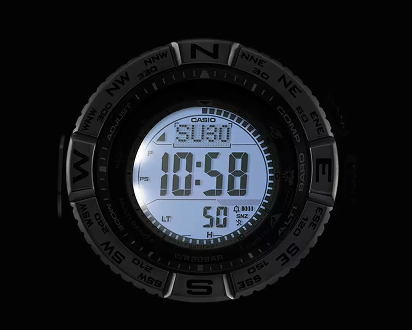 Digital Casio watch face displaying time 10:58 with compass bezel showing cardinal directions.