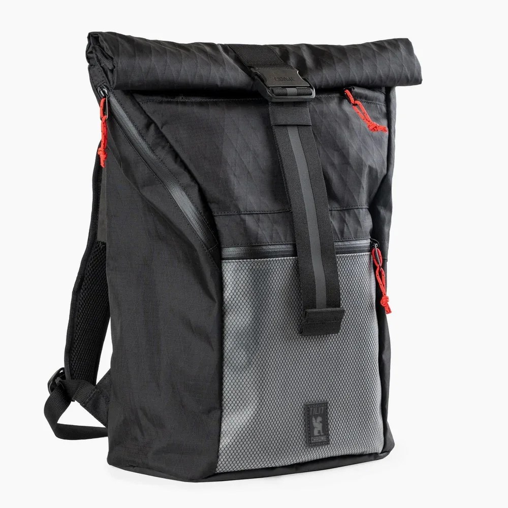 Black and gray roll-top backpack with red zipper pulls and a front buckle strap.