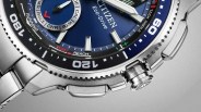 Close-up of a Citizen Eco-Drive watch with a blue dial, silver markers, and a stainless steel bracelet.