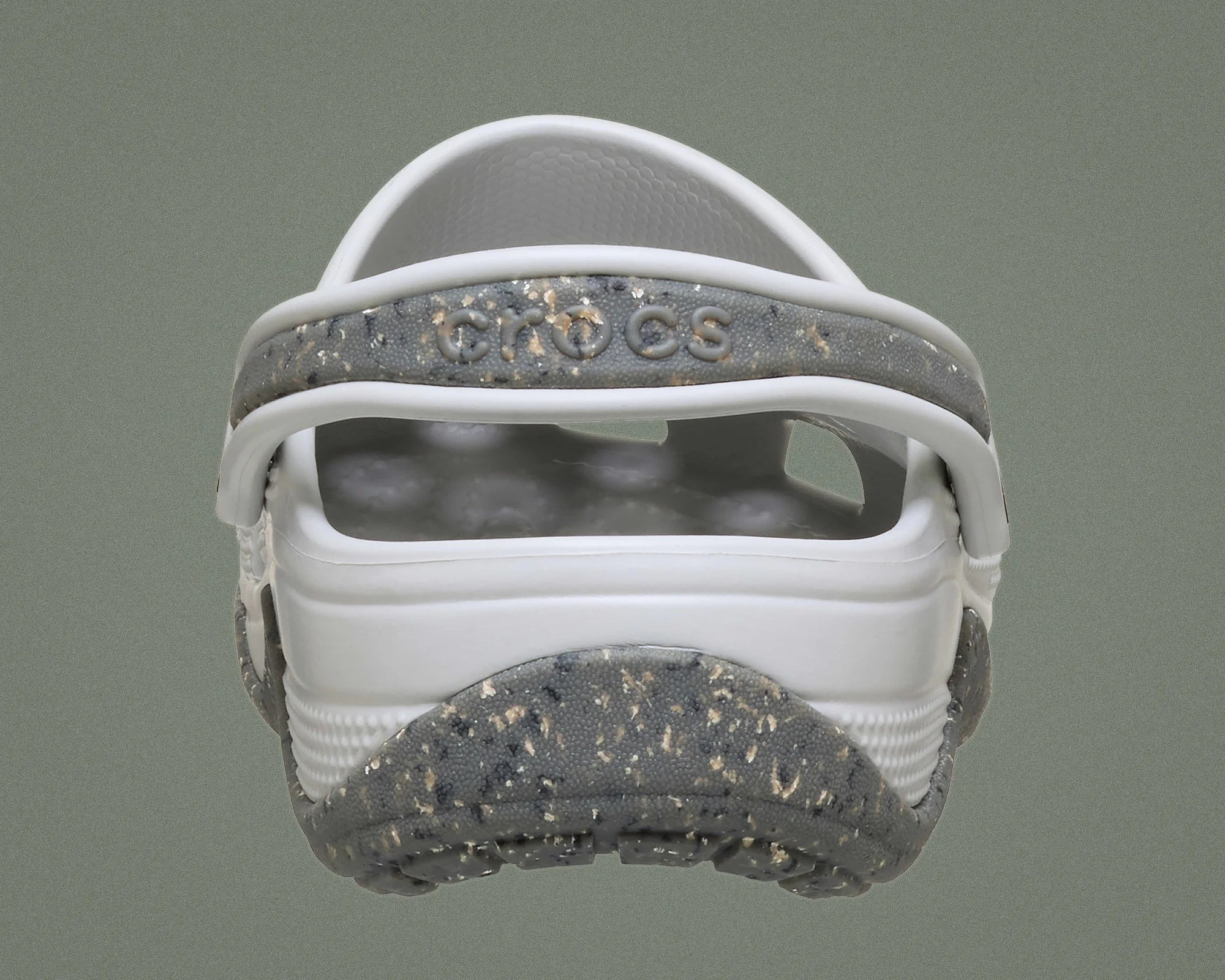Back view of a white Crocs sandal with a speckled gray strap and sole.