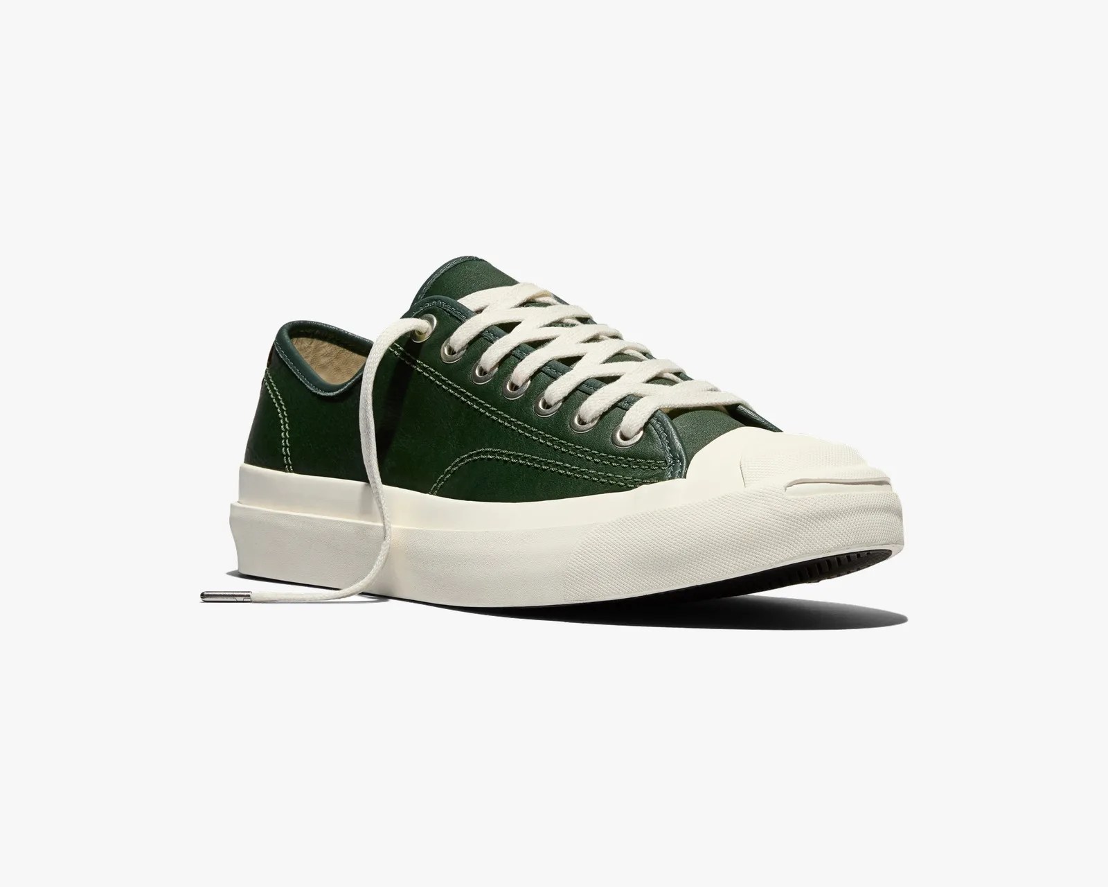 Dark green low-top sneaker with white thick rubber sole and white laces on a white background.