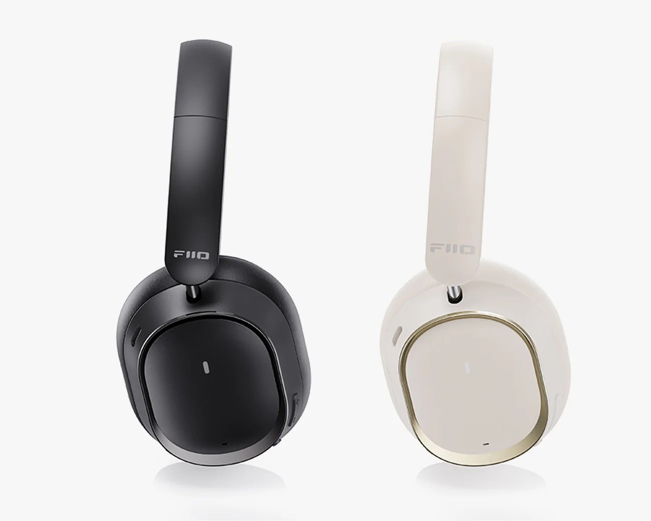 Two over-ear wireless headphones, one black and one white with gold trim, both with FiiO branding on the headbands.