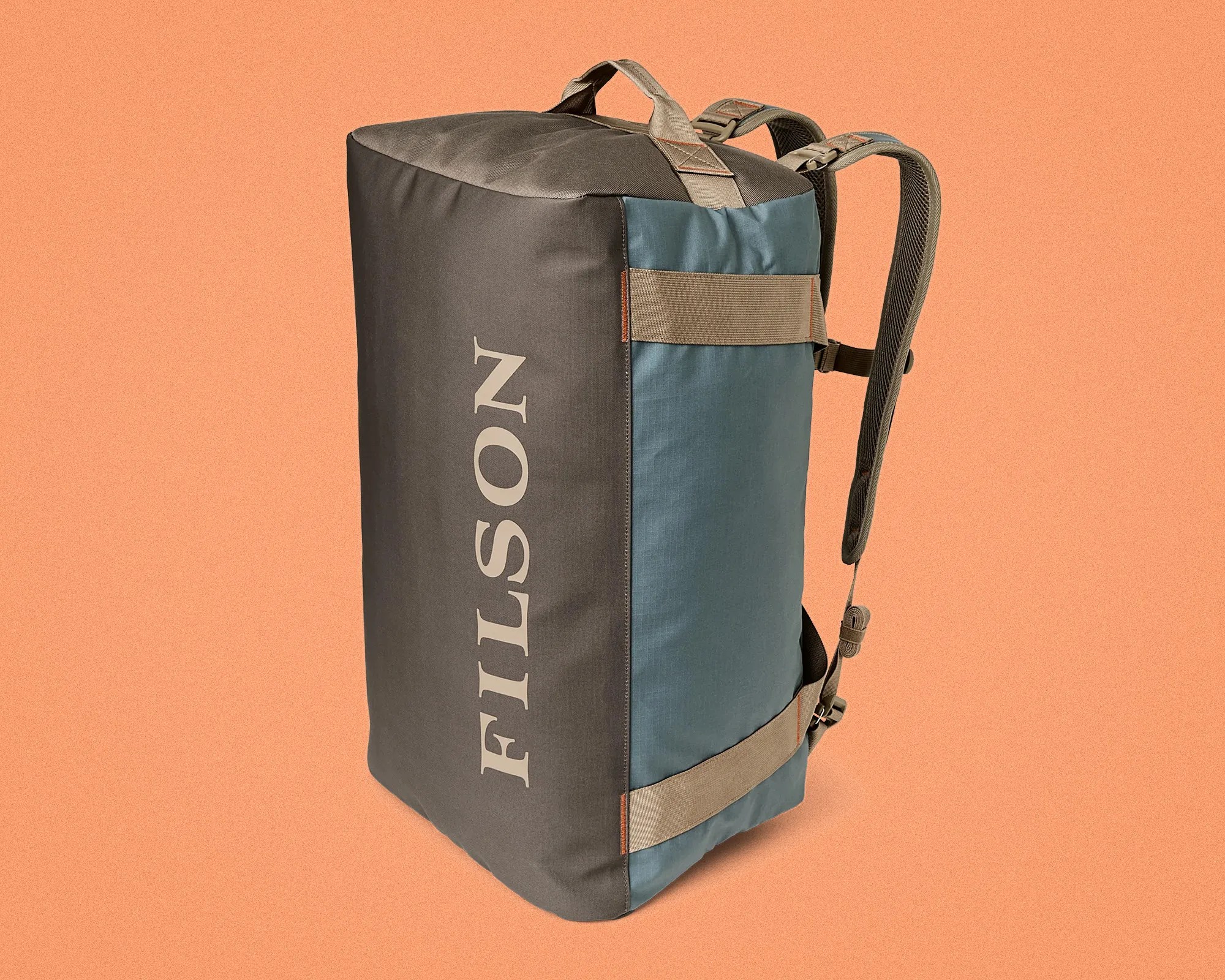 Two-tone blue and gray rectangular backpack with beige straps and partial "FILSON" logo on the side.