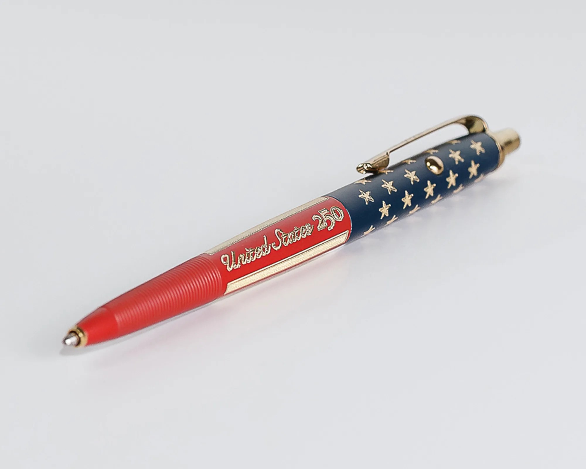 Ballpoint pen with red, white, and blue design featuring gold stars and "United States 250" text.
