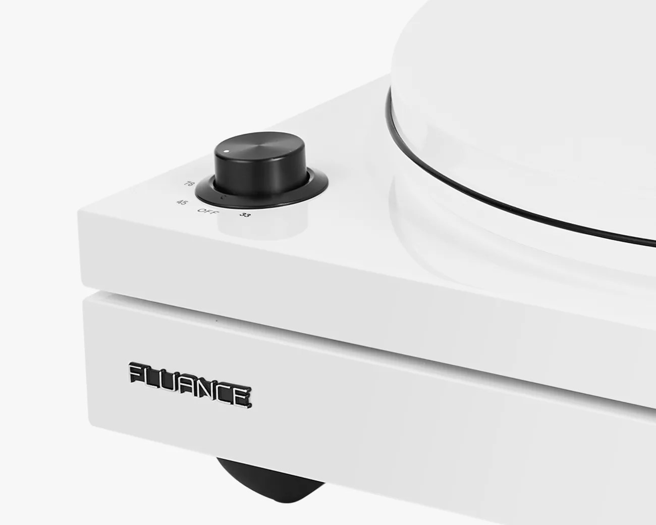 Close-up of a white Fluance turntable with a black speed control knob showing 33, 45, and 78 RPM settings.
