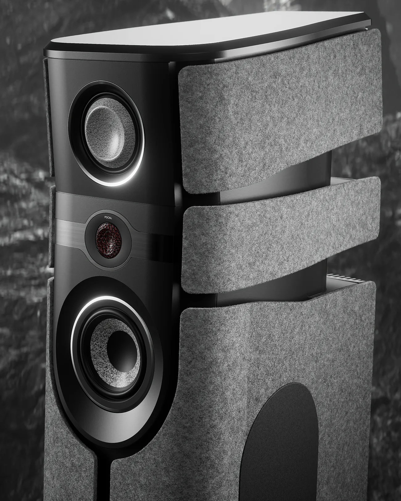 Black high-end speaker with three drivers and gray felt acoustic panels on the sides.