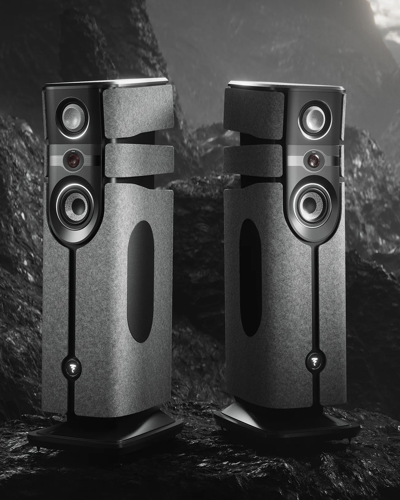 Pair of tall, gray fabric-covered floor-standing speakers with black bases and multiple drivers.