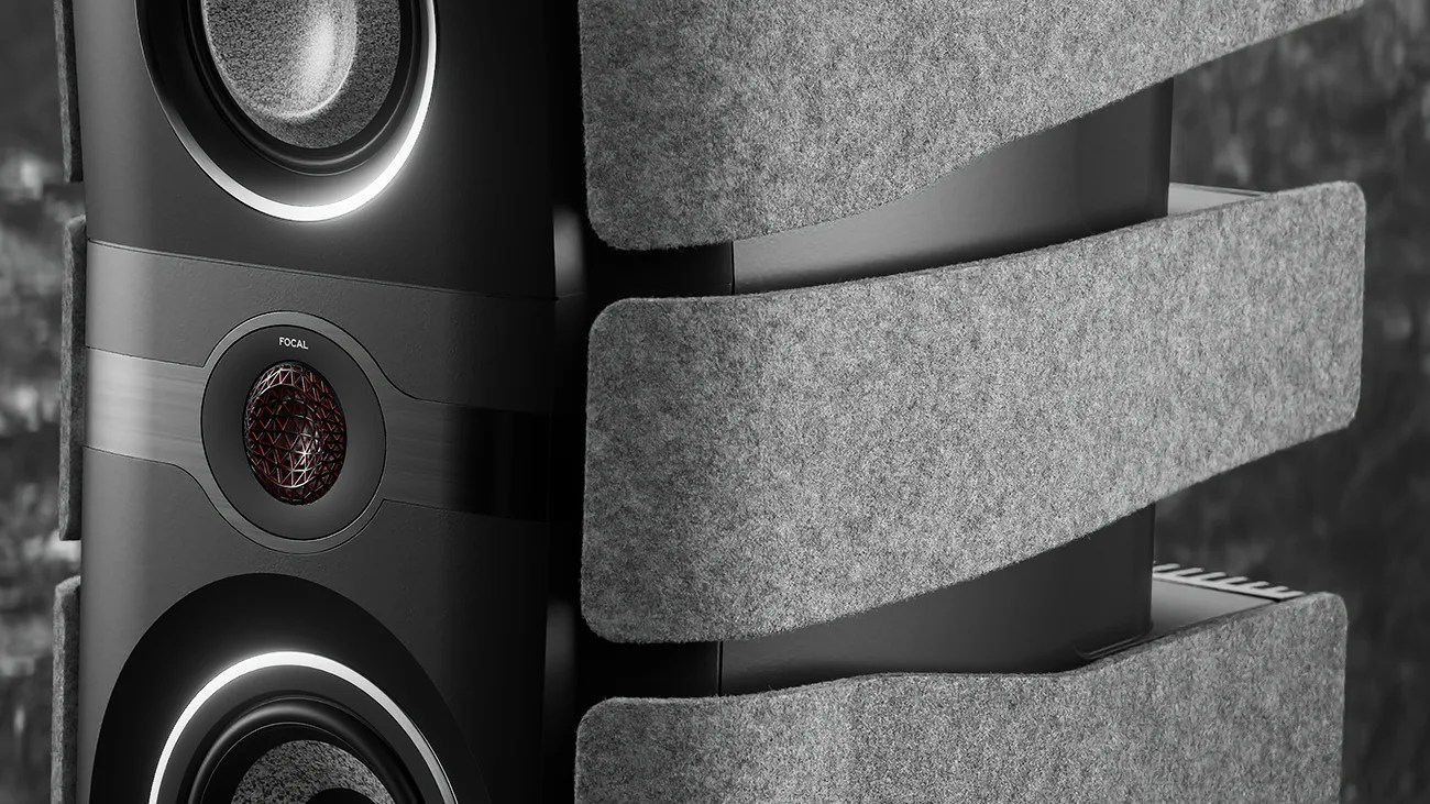 Close-up of a black Focal speaker with illuminated rings around the drivers and gray acoustic panels attached.