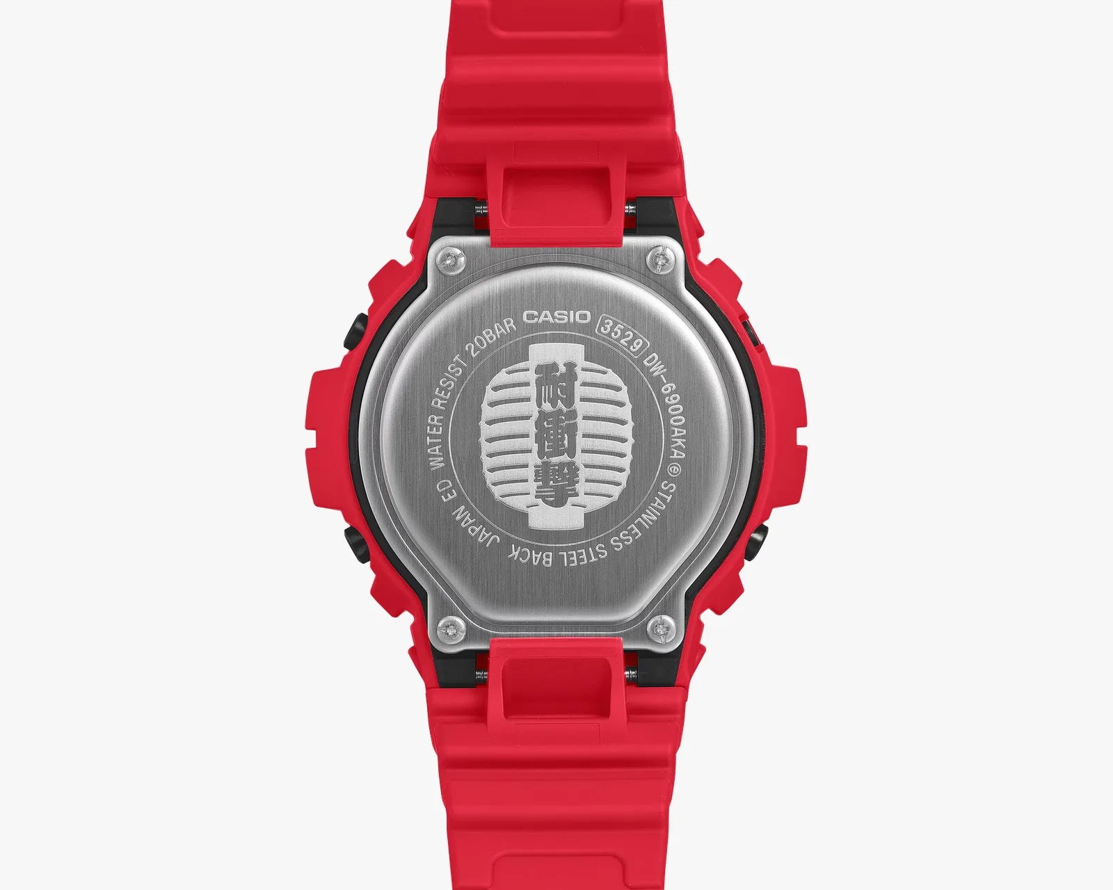 Back of a Casio DW-6900AKA watch with red resin strap and stainless steel case back showing model number and water resistance details.