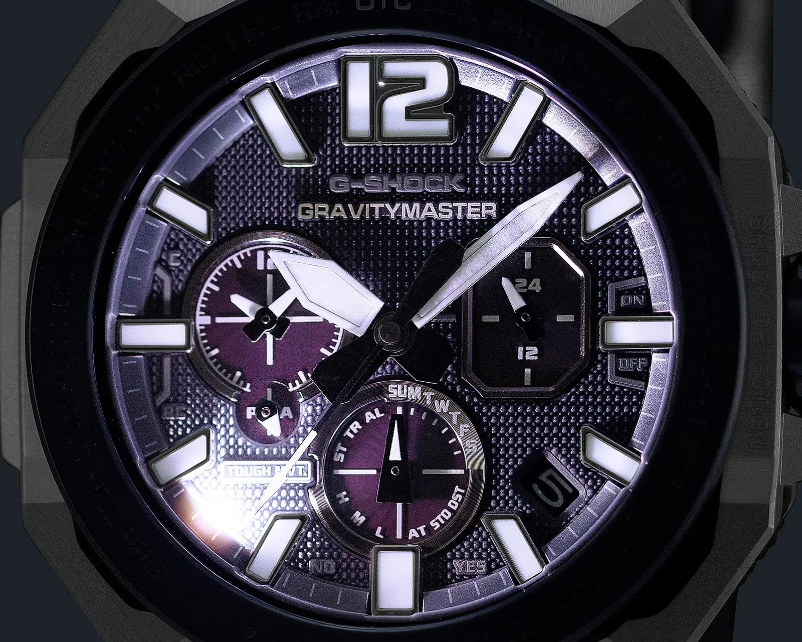 Close-up of a black G-Shock Gravitymaster watch face with white hour markers and multiple subdials.