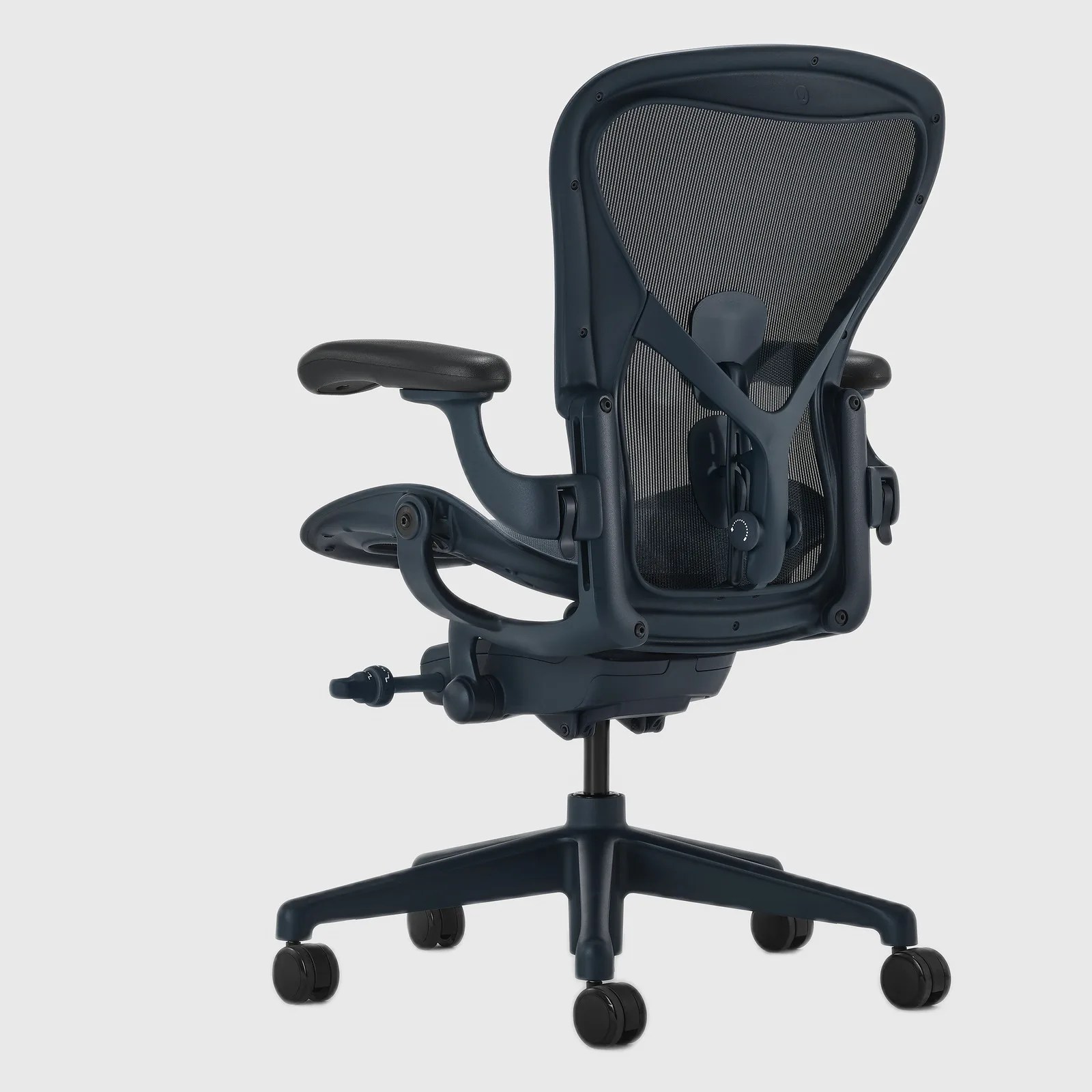 Ergonomic black office chair with mesh backrest, adjustable armrests, and five caster wheels on a swivel base.