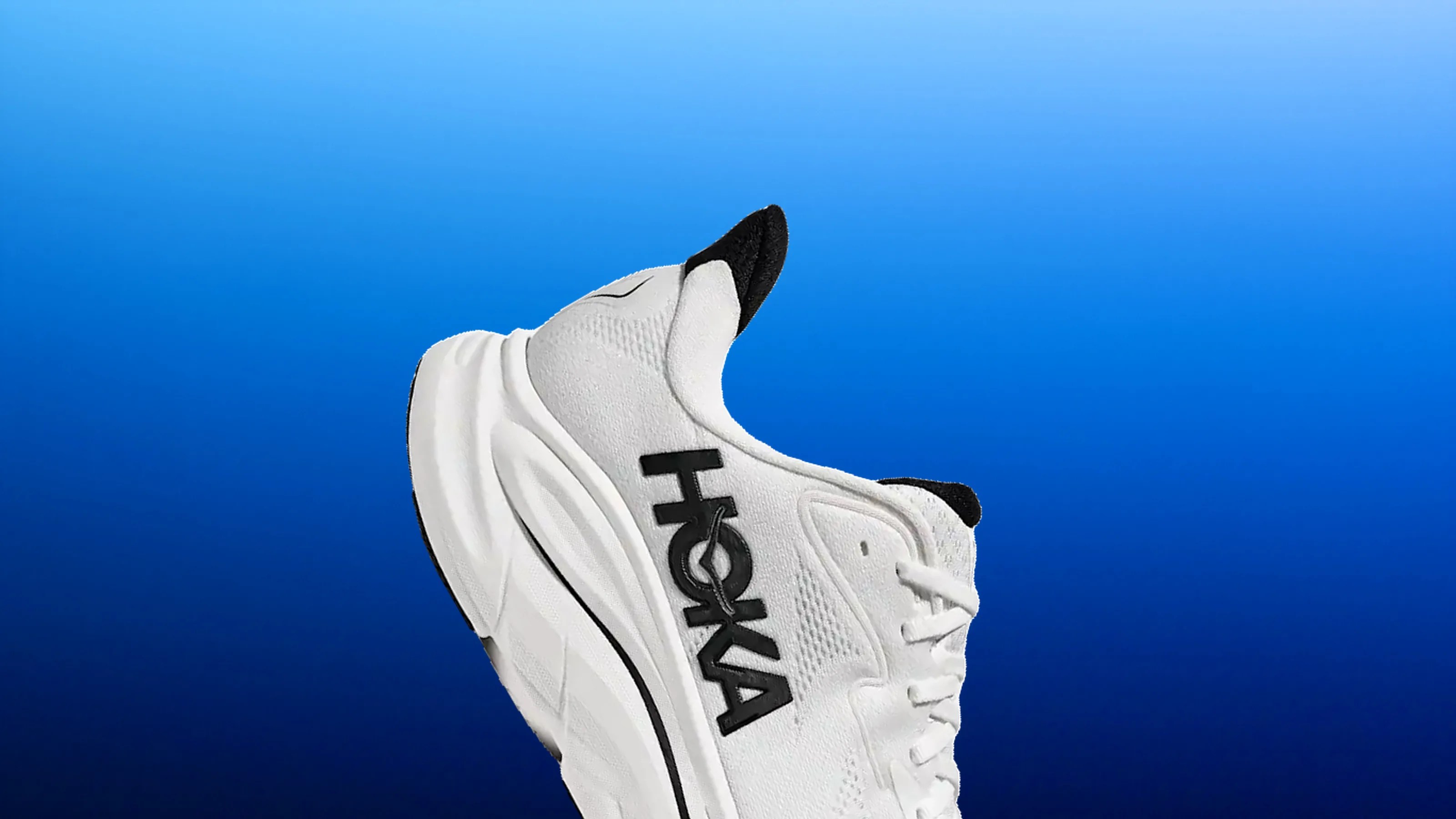 White Hoka running shoe with black logo and accents against a blue gradient background.