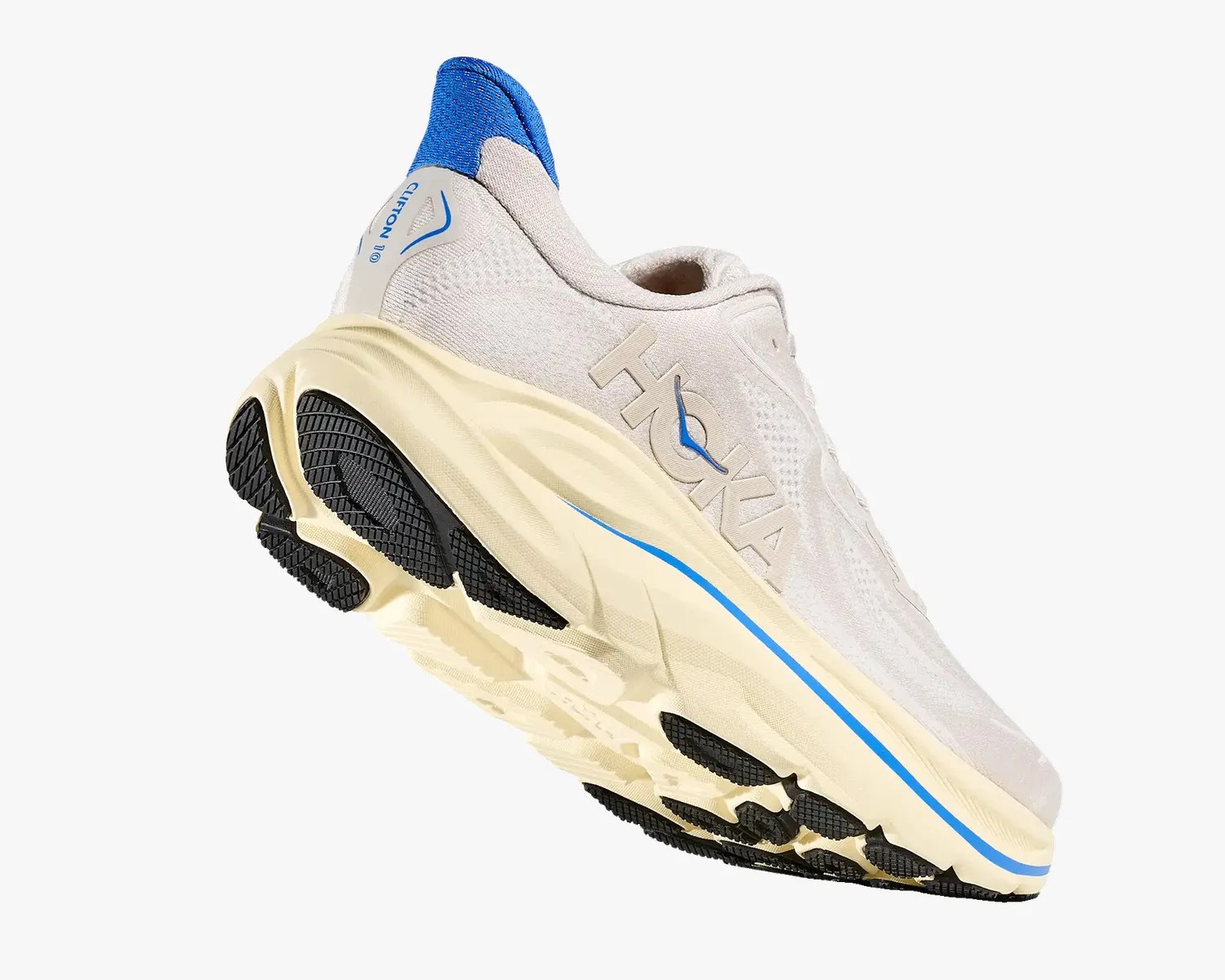 Light beige Hoka Clifton 10 running shoe with blue heel collar and black outsole tread.