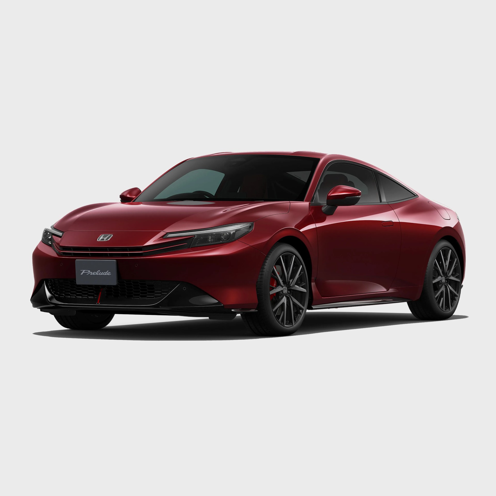 Red Honda Prelude coupe with black alloy wheels and tinted windows on a white background.