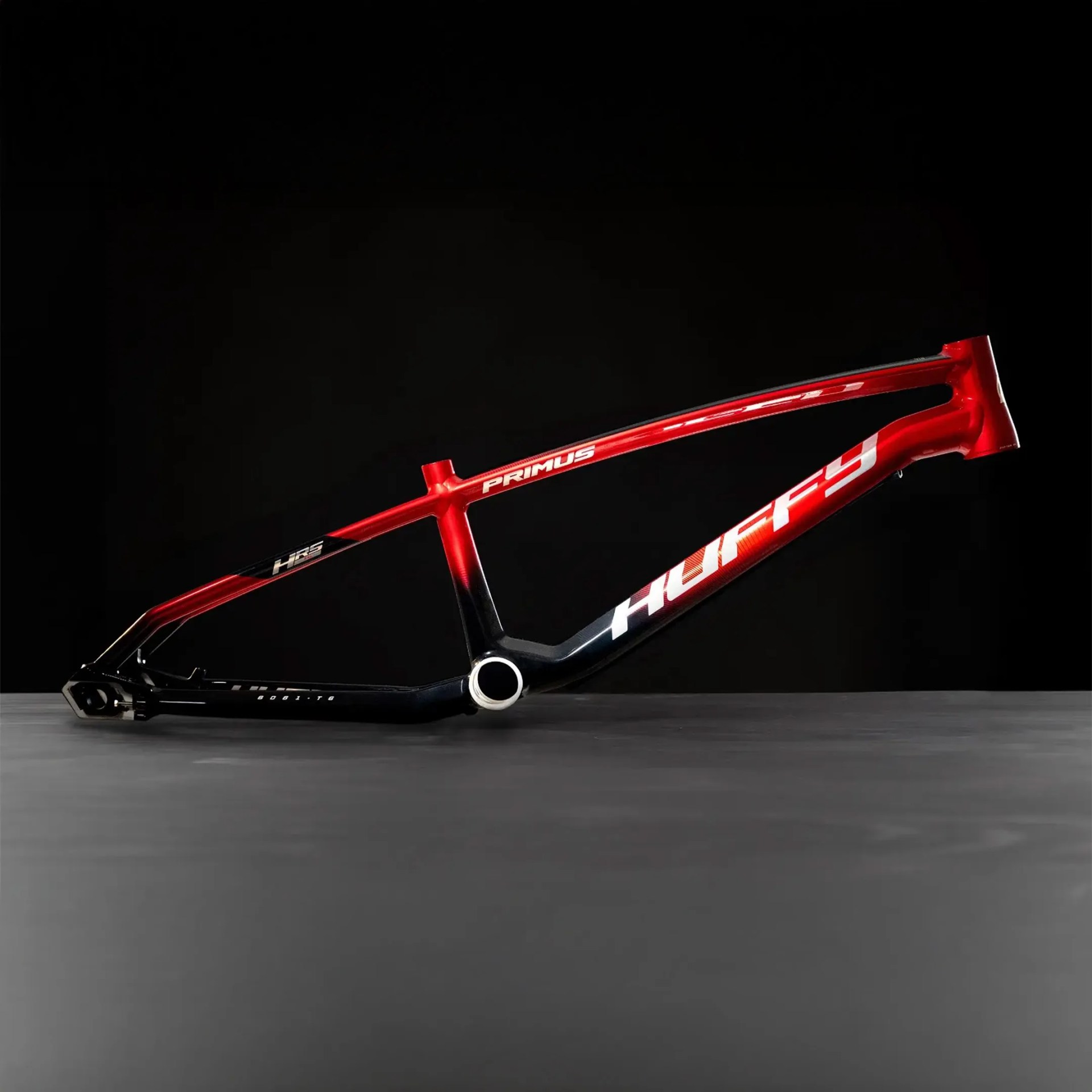 Red and black Huffy Primus bicycle frame on a dark background.