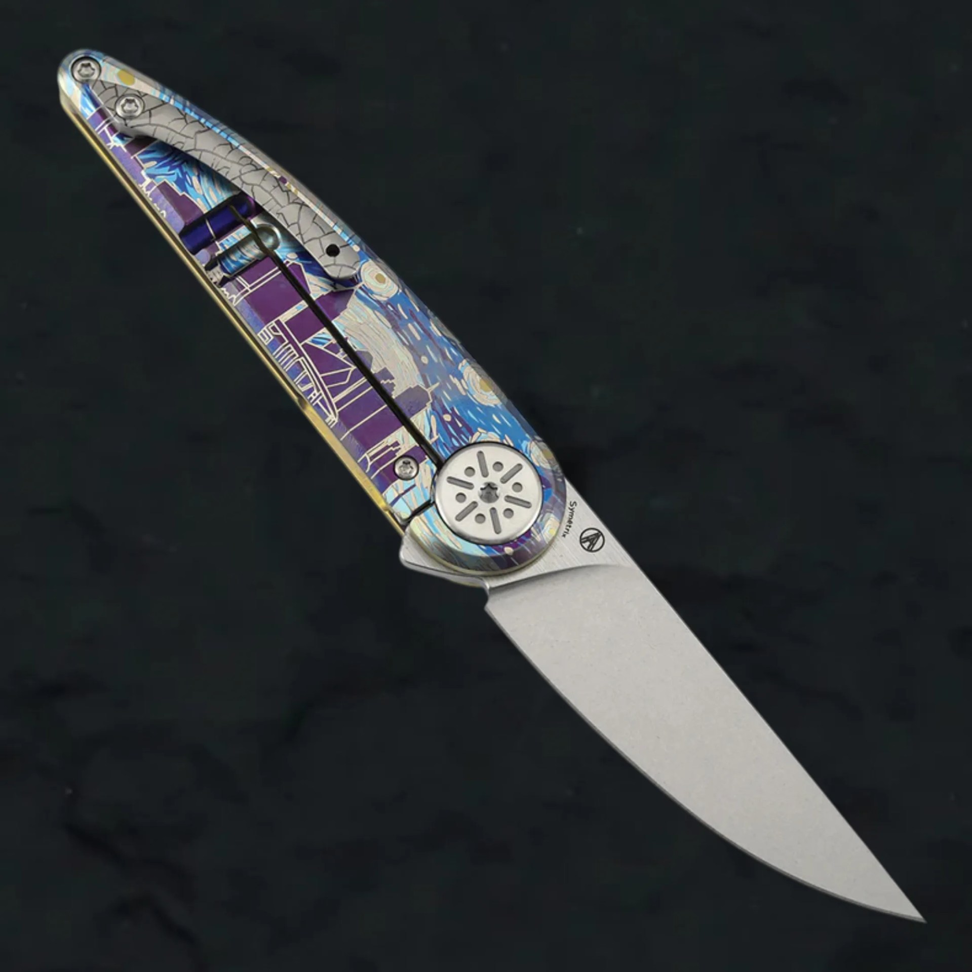 Folding knife with a silver blade and a handle featuring a colorful, abstract blue and purple design.