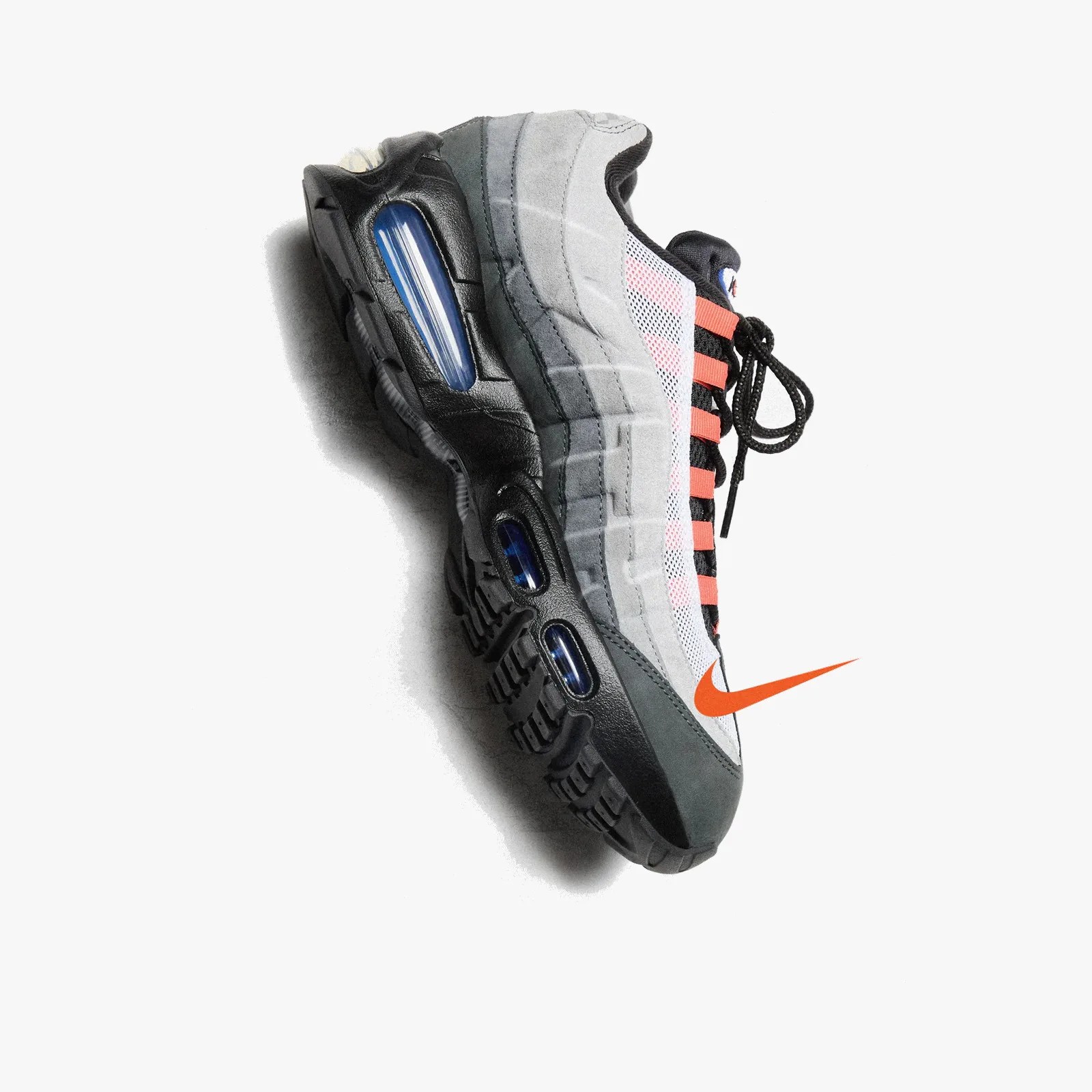 Gray and black Nike Air Max sneaker with orange accents and visible blue air cushioning on a white background.