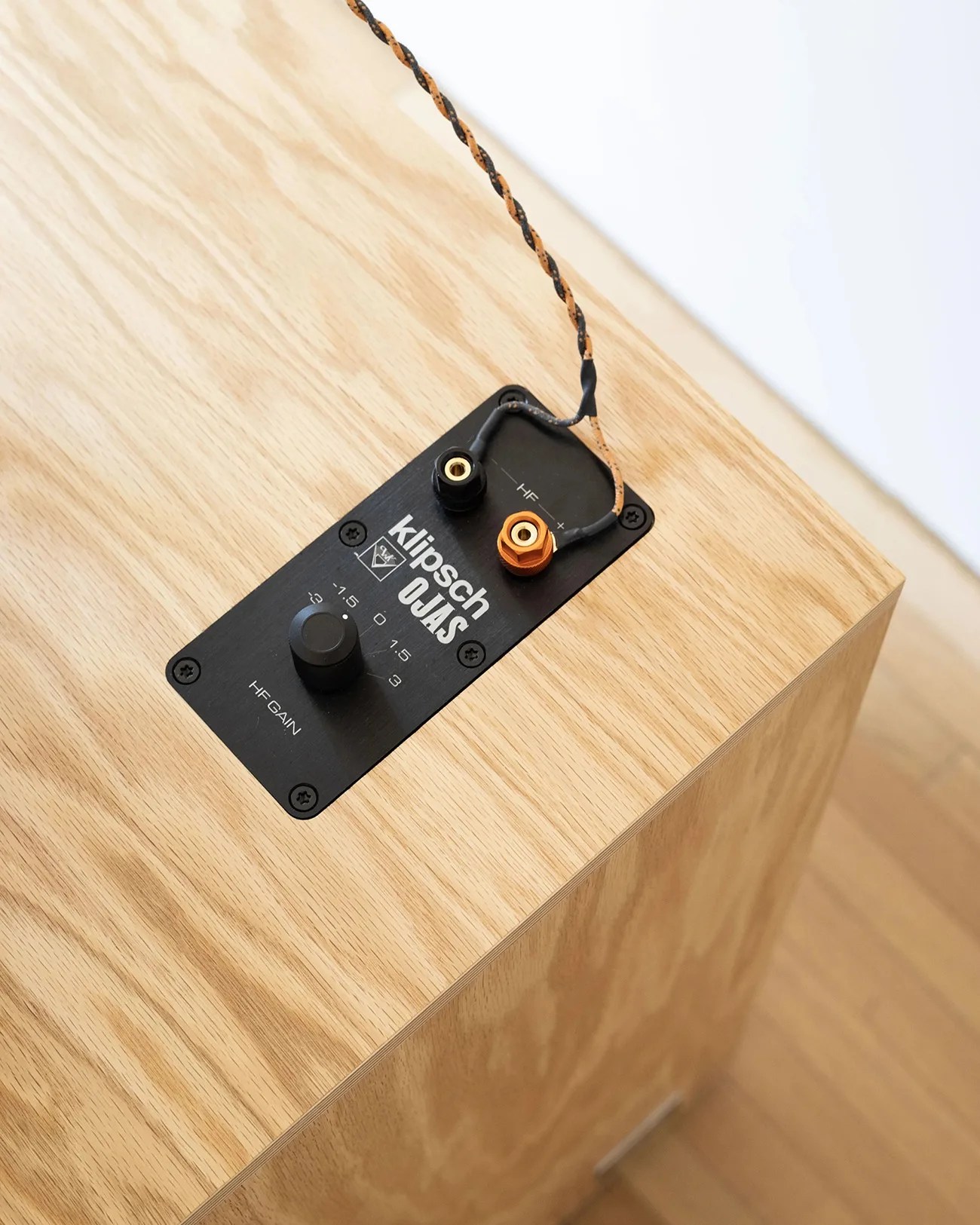 Black control panel with Klipsch OJAS branding, HF gain knob, and speaker wire terminals on a light wood speaker cabinet.