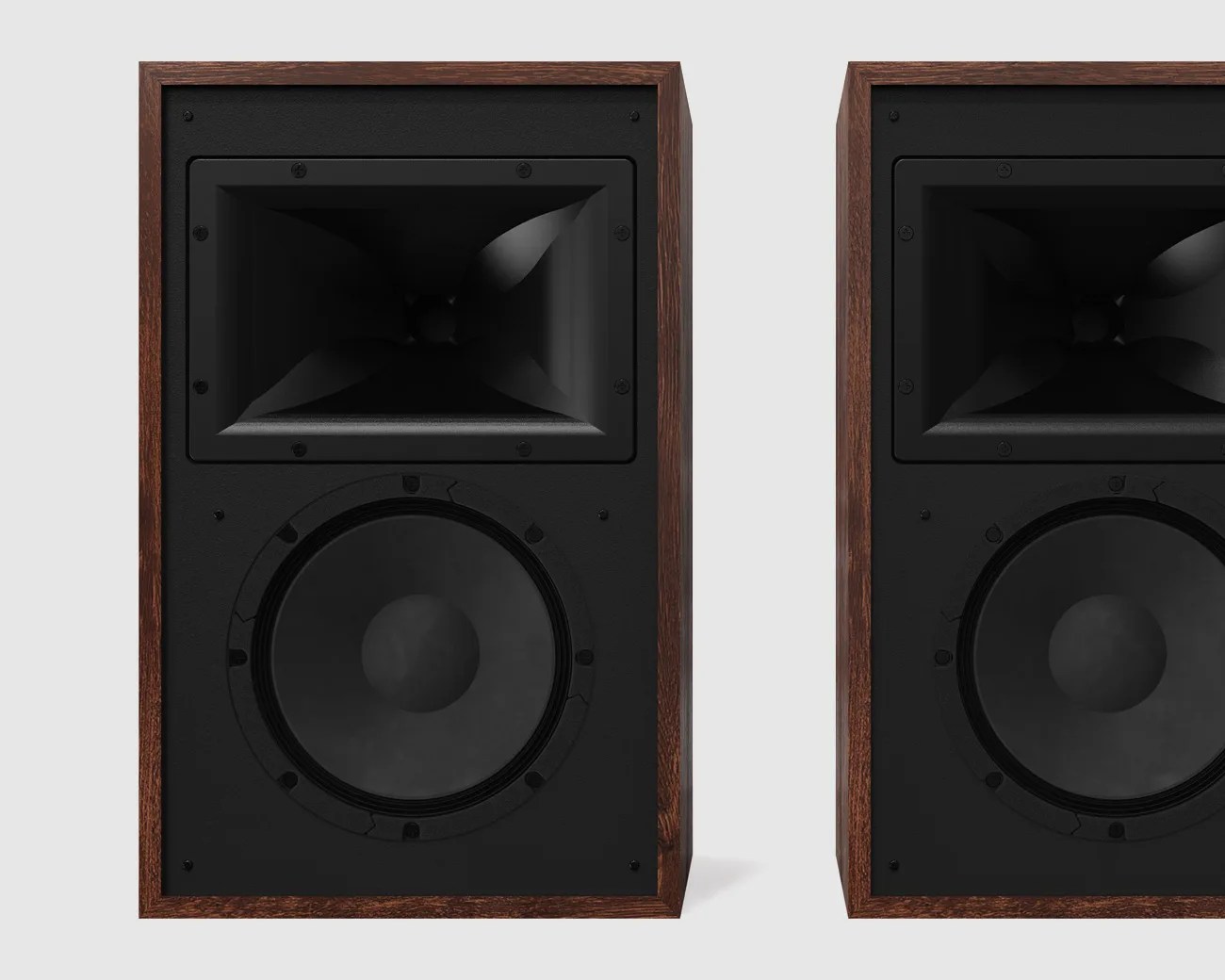 Pair of vintage-style speakers with dark wood frames and black speaker cones on a light background.