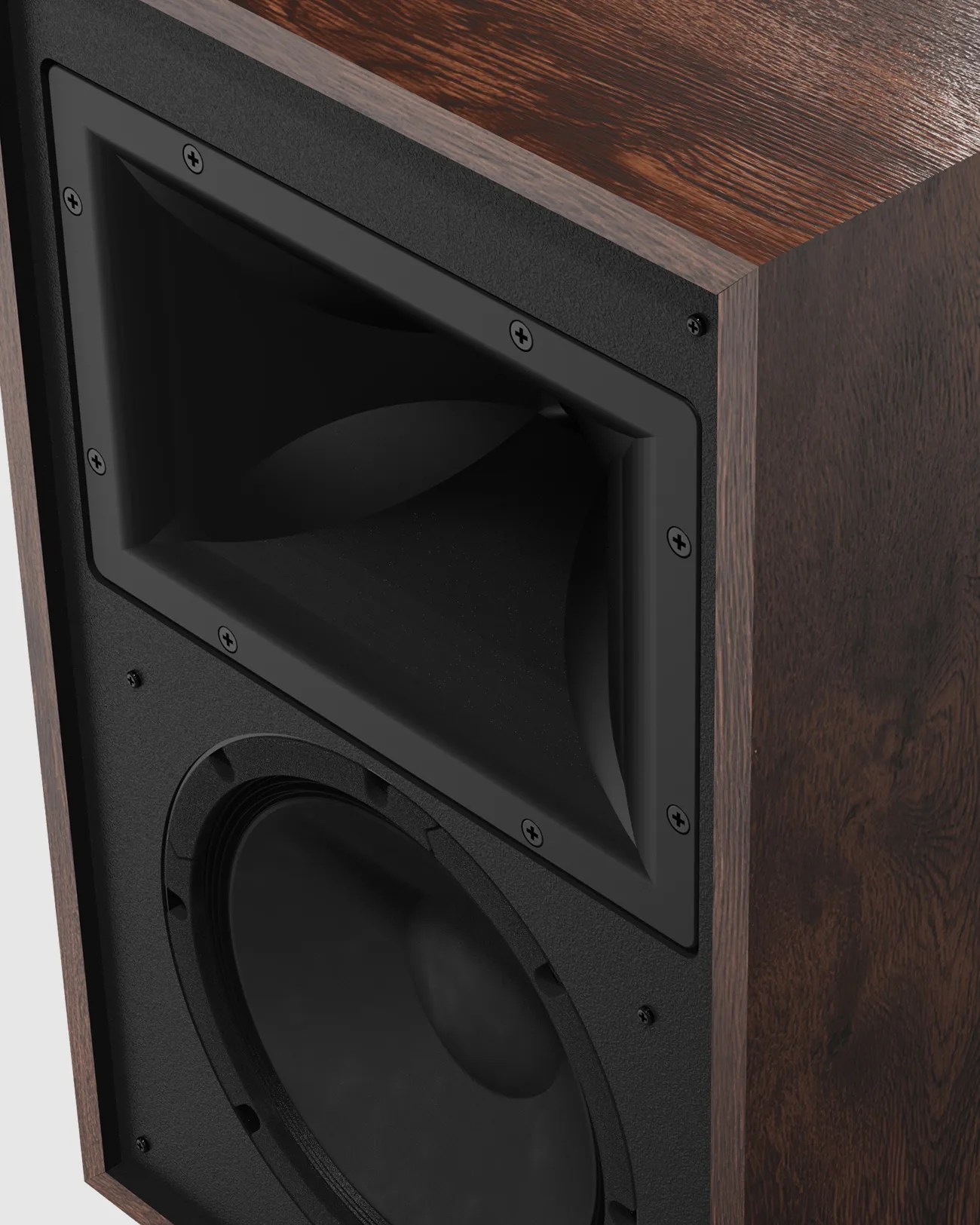 Close-up of a wooden speaker cabinet featuring a black horn tweeter and woofer.
