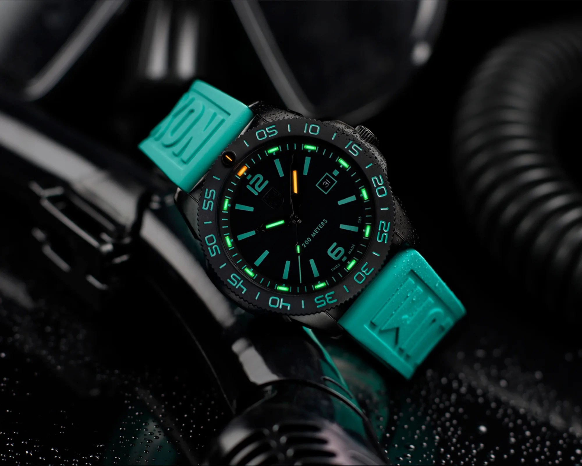 Black dive watch with glowing green and orange markers and turquoise rubber strap on a wet black surface.