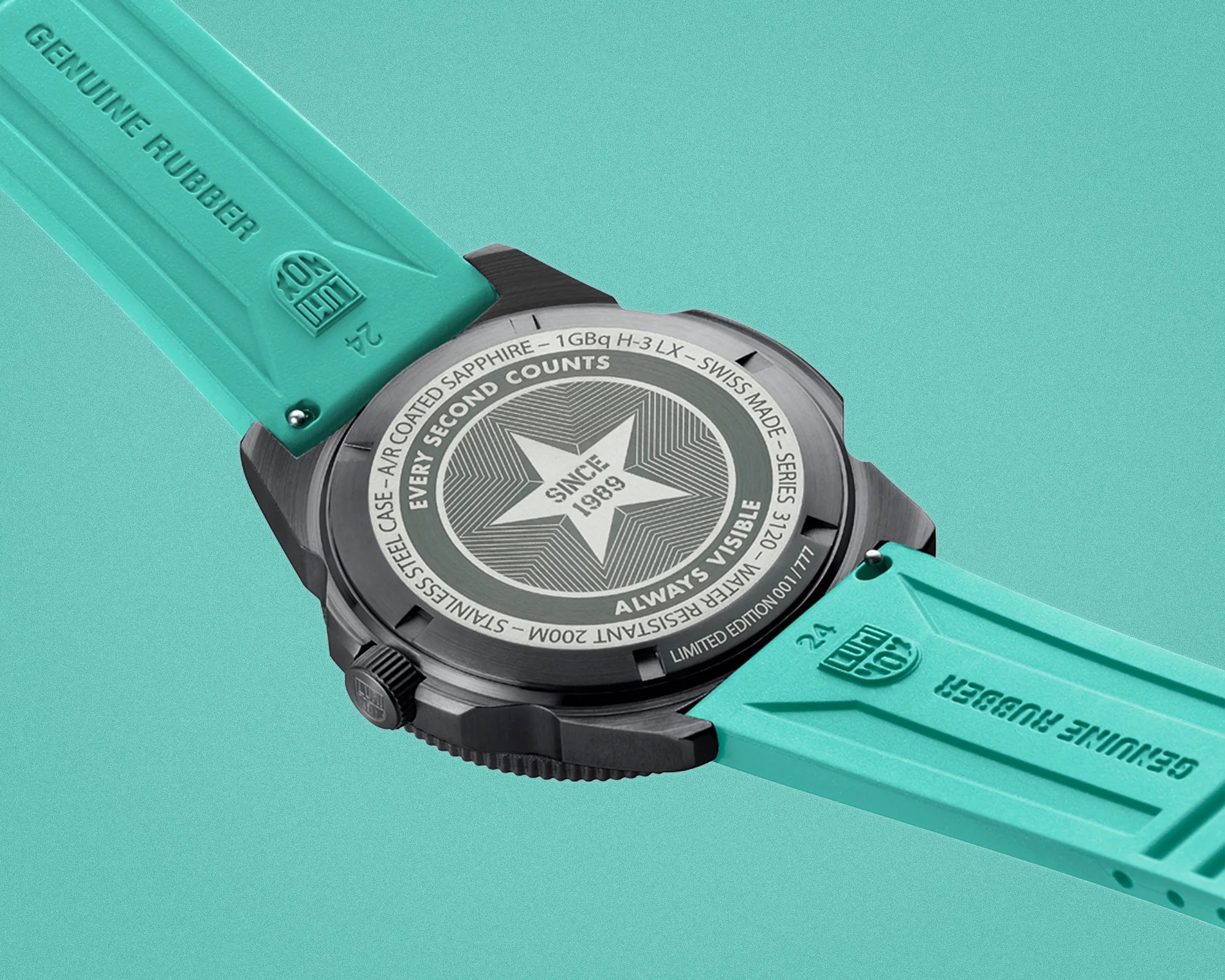 Close-up of the back of a black stainless steel watch with a turquoise genuine rubber strap.