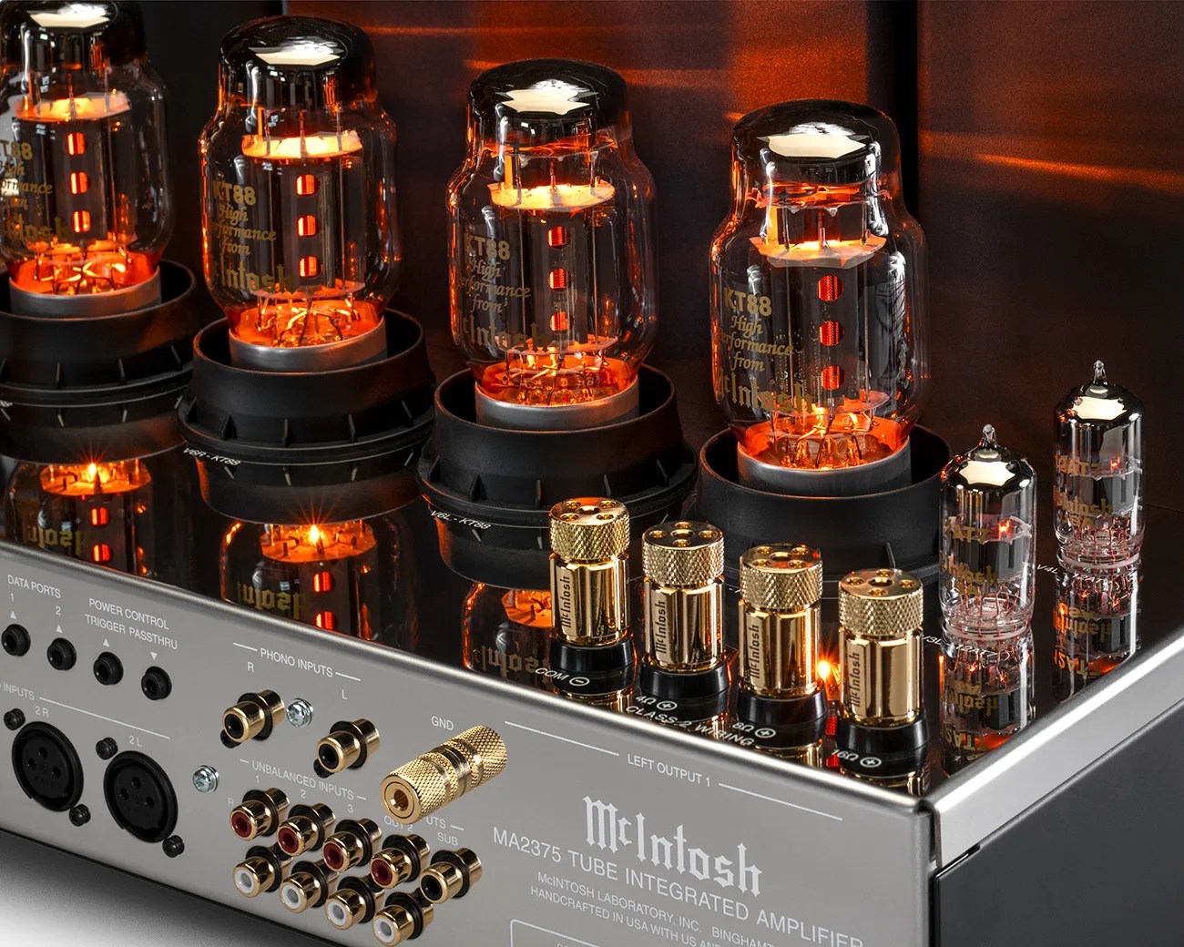 Silver McIntosh MA2375 tube integrated amplifier with glowing KT88 vacuum tubes and gold-plated connectors.