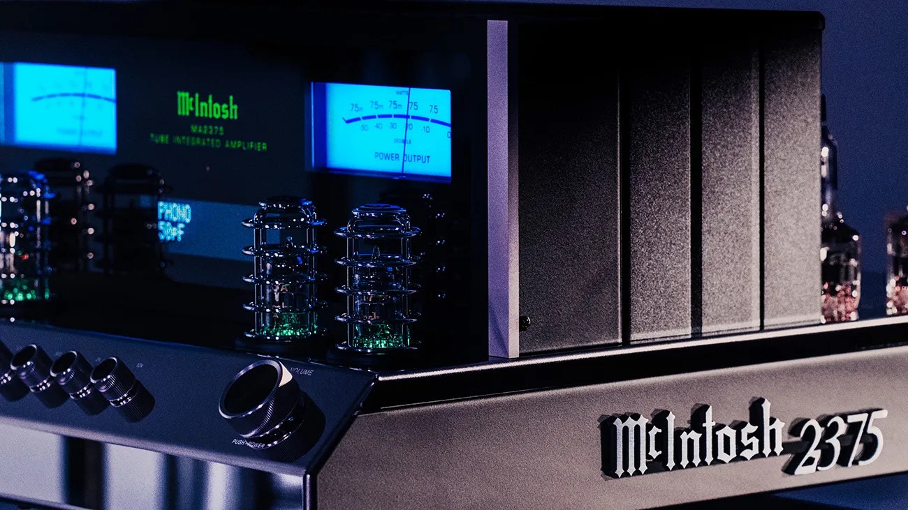 McIntosh 2375 vintage integrated amplifier with glowing vacuum tubes and blue-lit power meters.