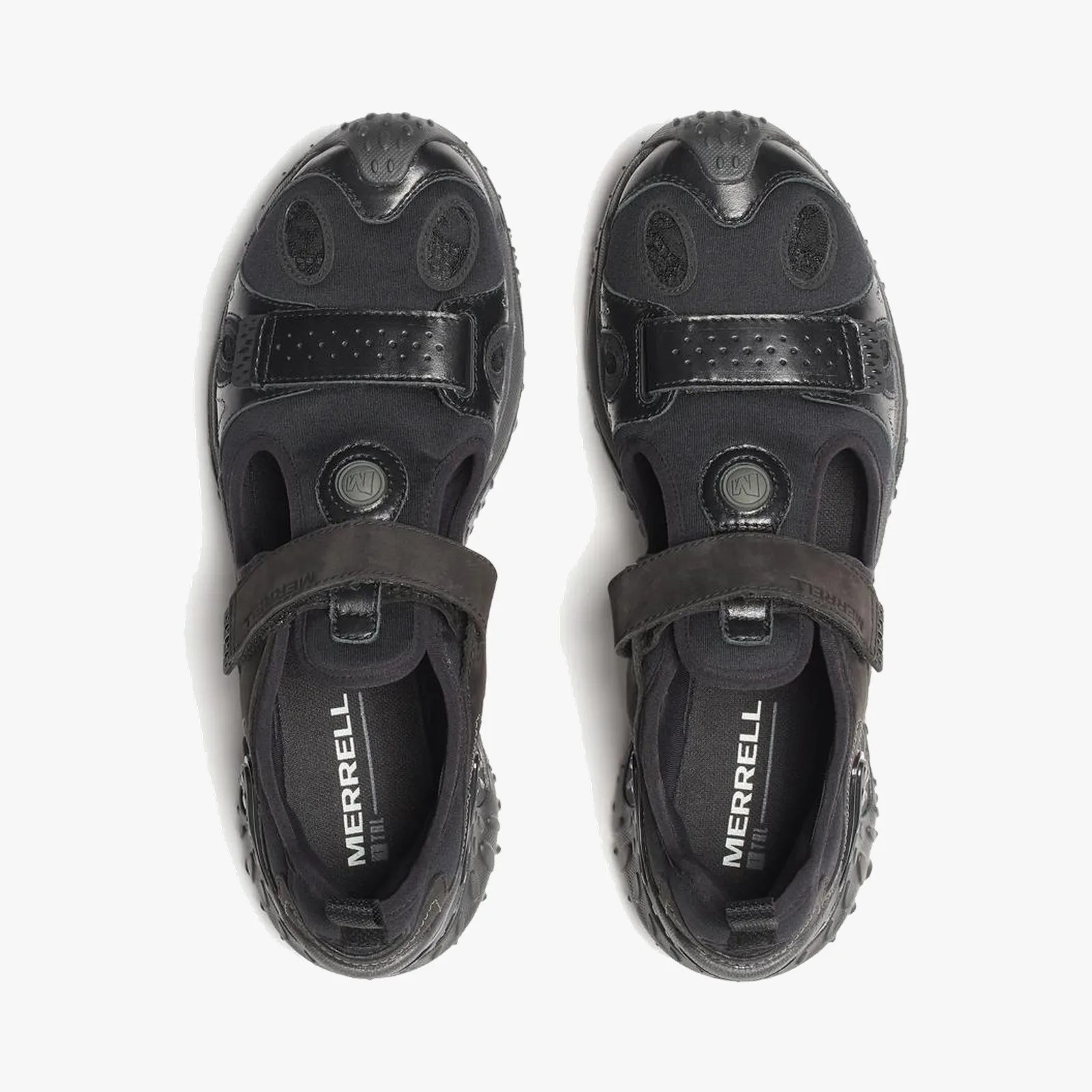 Pair of black Merrell shoes with Velcro straps and textured rubber toe caps, viewed from above.