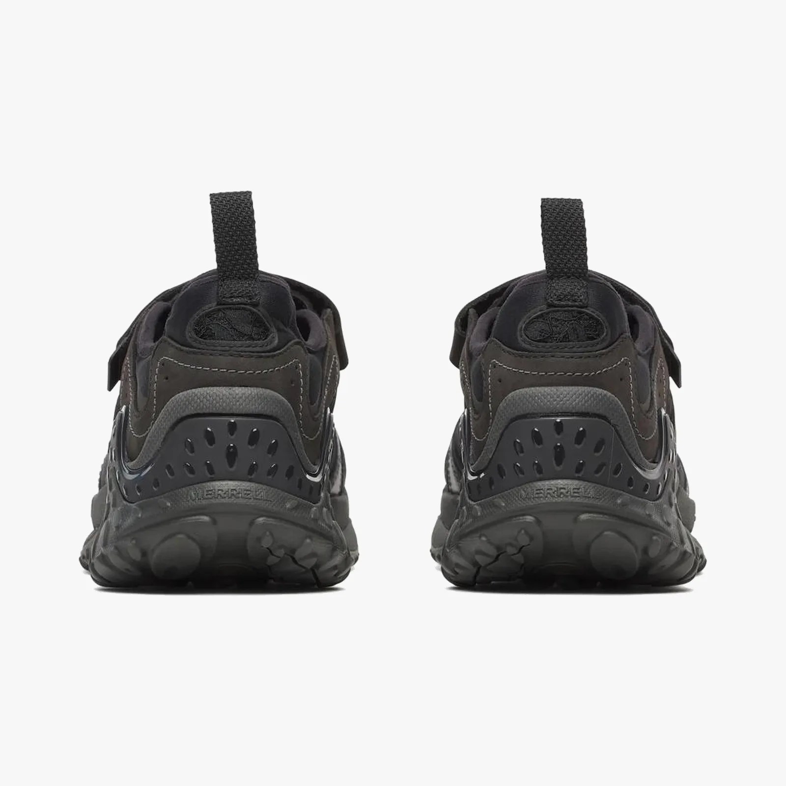 Pair of black athletic shoes with textured soles and pull tabs at the heel, viewed from the back.