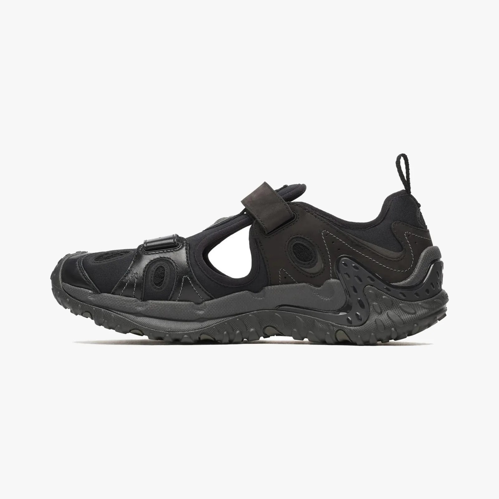 Black athletic sandal with rugged sole and cutout sides.