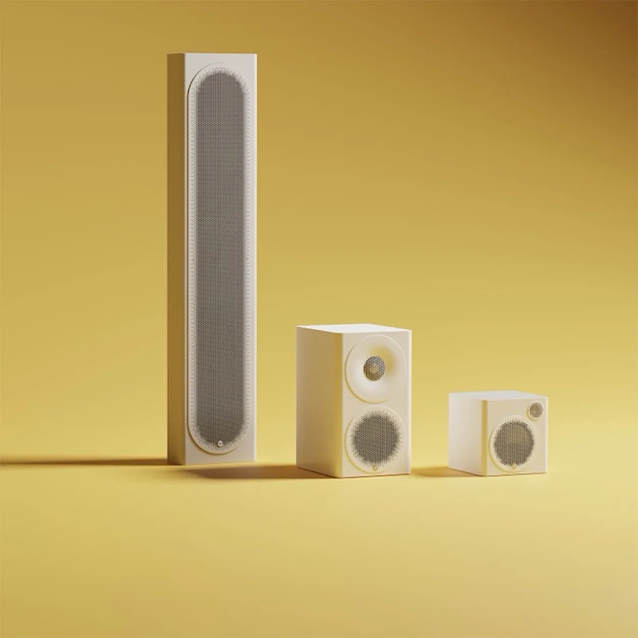 Three cream-colored speakers of varying sizes with gray speaker grilles on a yellow background.