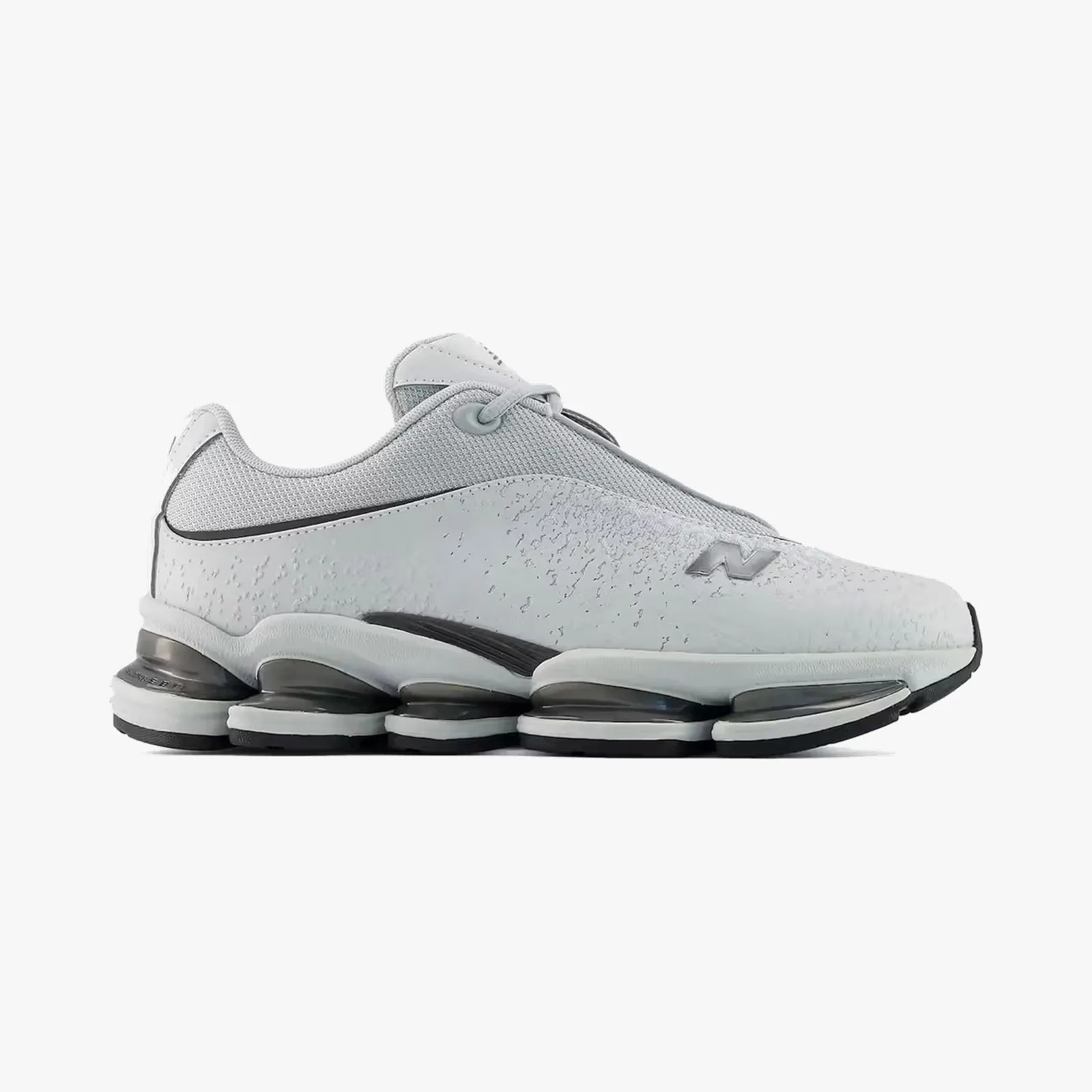 Light gray athletic shoe with mesh upper, textured side panel, and segmented black and white cushioned sole.