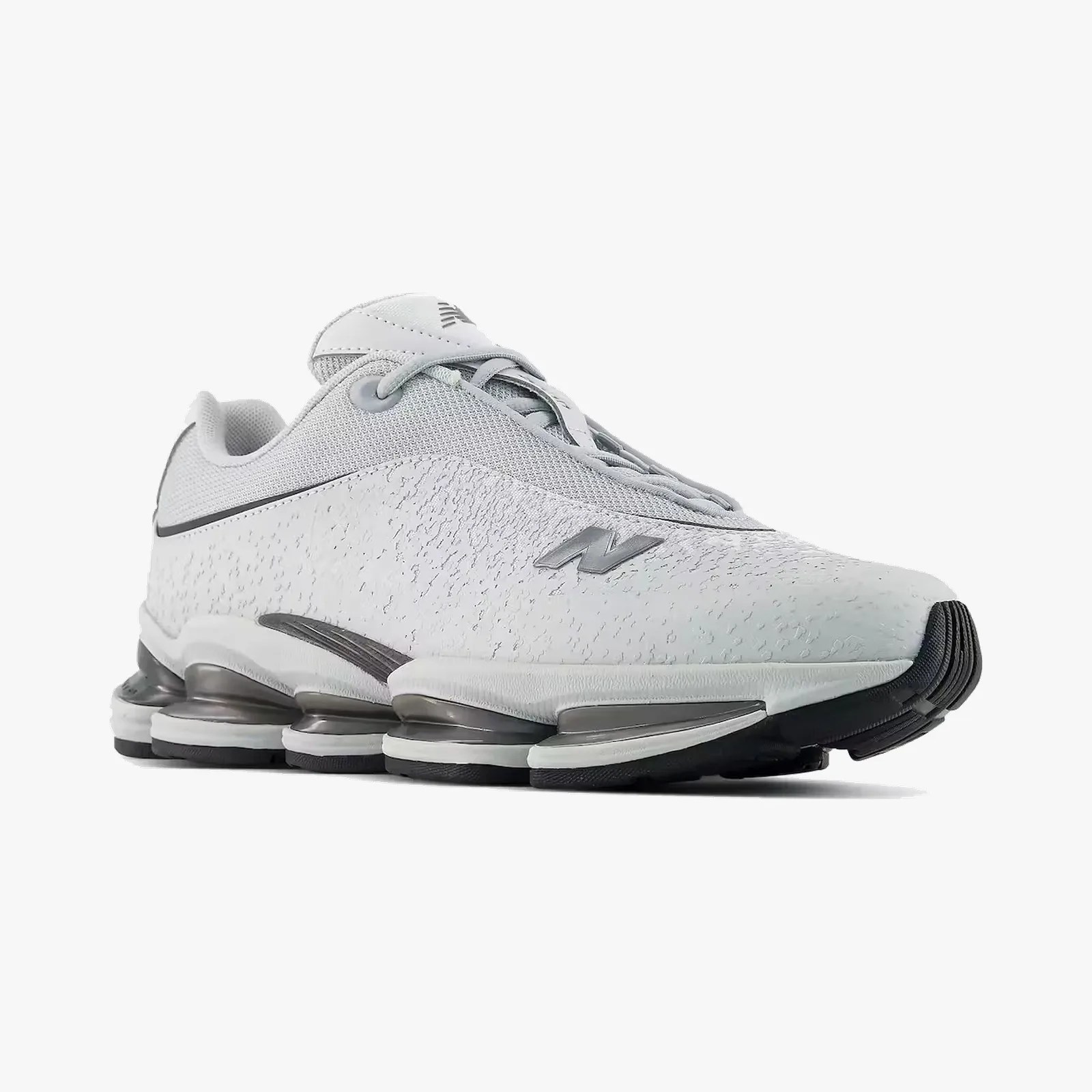 White New Balance sneaker with textured upper and segmented black and gray sole.