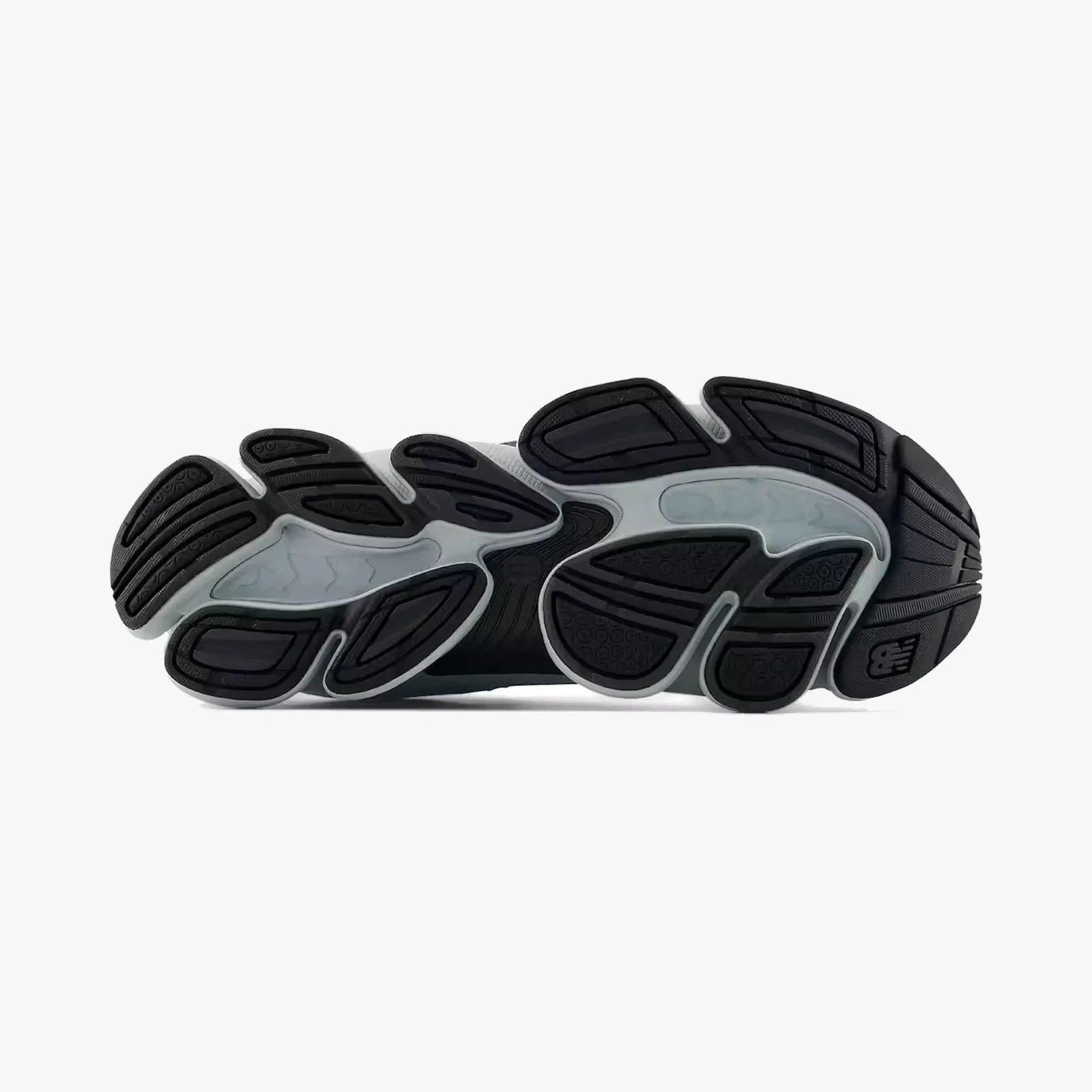 Black and gray New Balance shoe sole with textured grip patterns and logo near the heel.