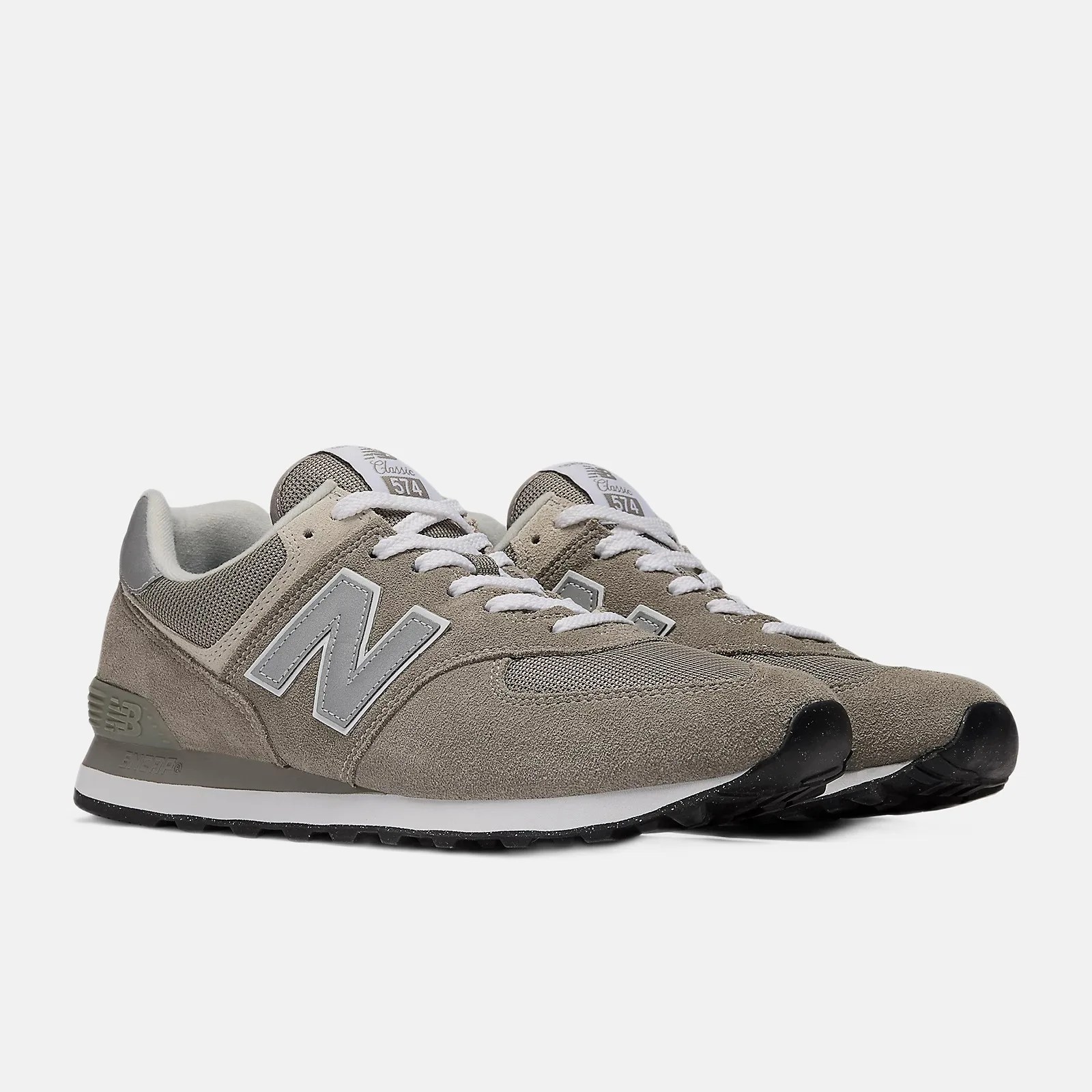 Pair of gray New Balance 574 Classic sneakers with white laces and black soles.