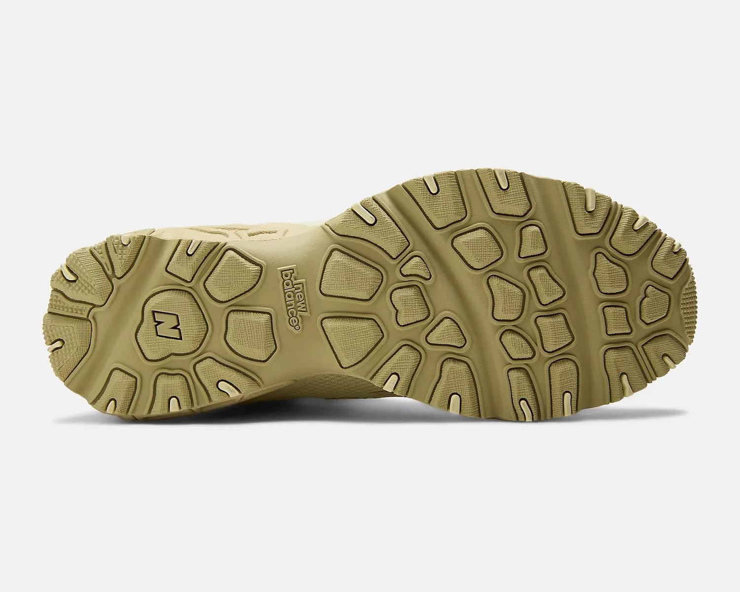 Beige New Balance shoe sole with textured grip pattern and logo in the center.