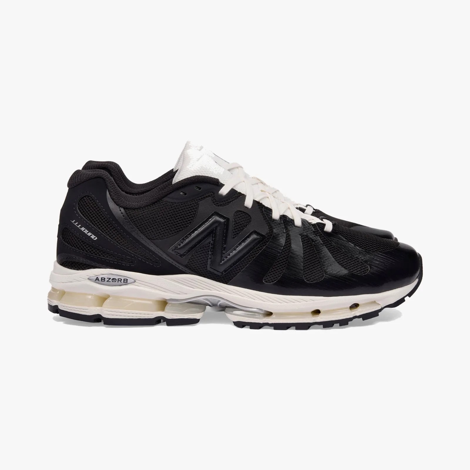 Black and white New Balance running shoe with mesh upper and cushioned sole labeled "ABZORB.