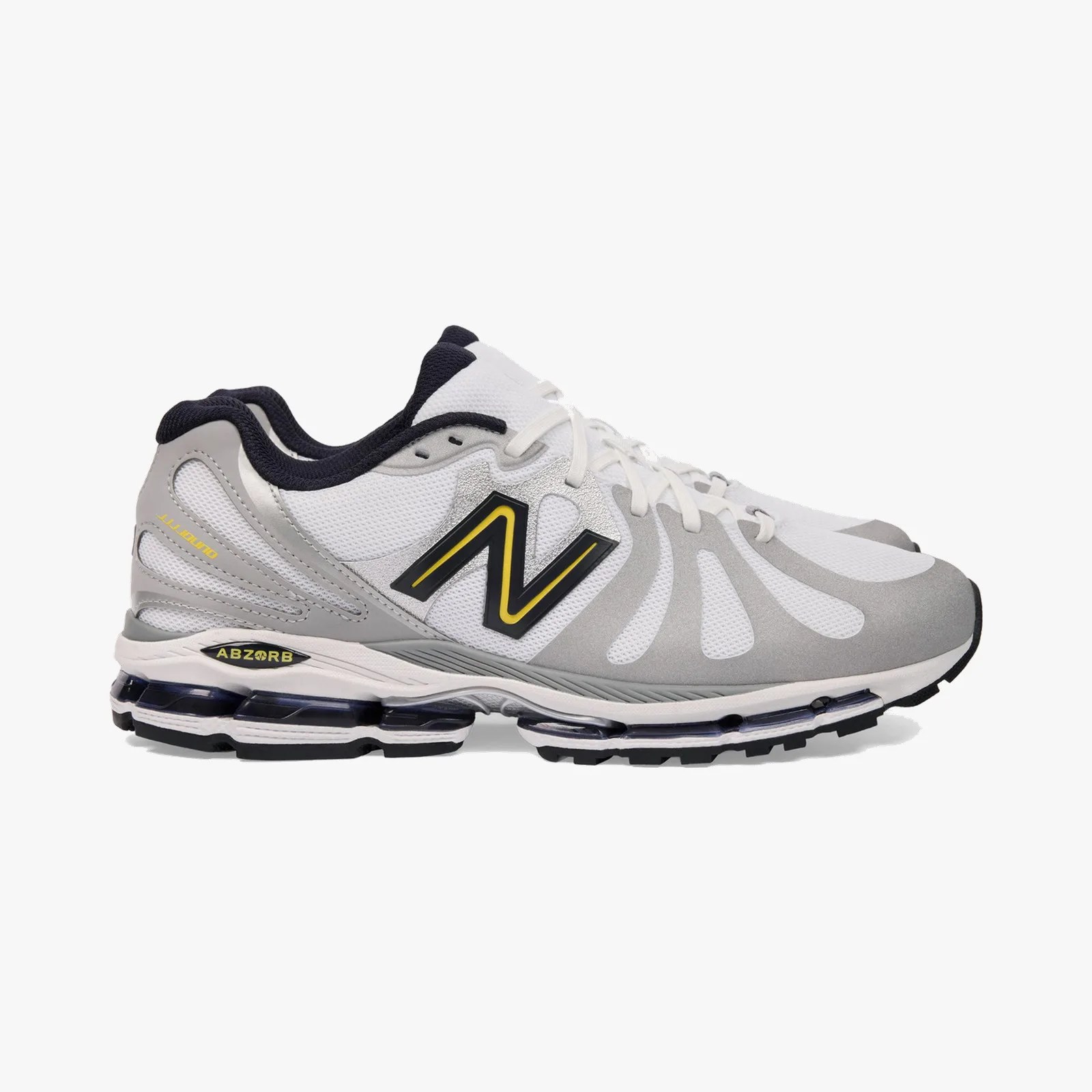 White and gray New Balance running shoe with black and yellow logo and visible cushioning sole.
