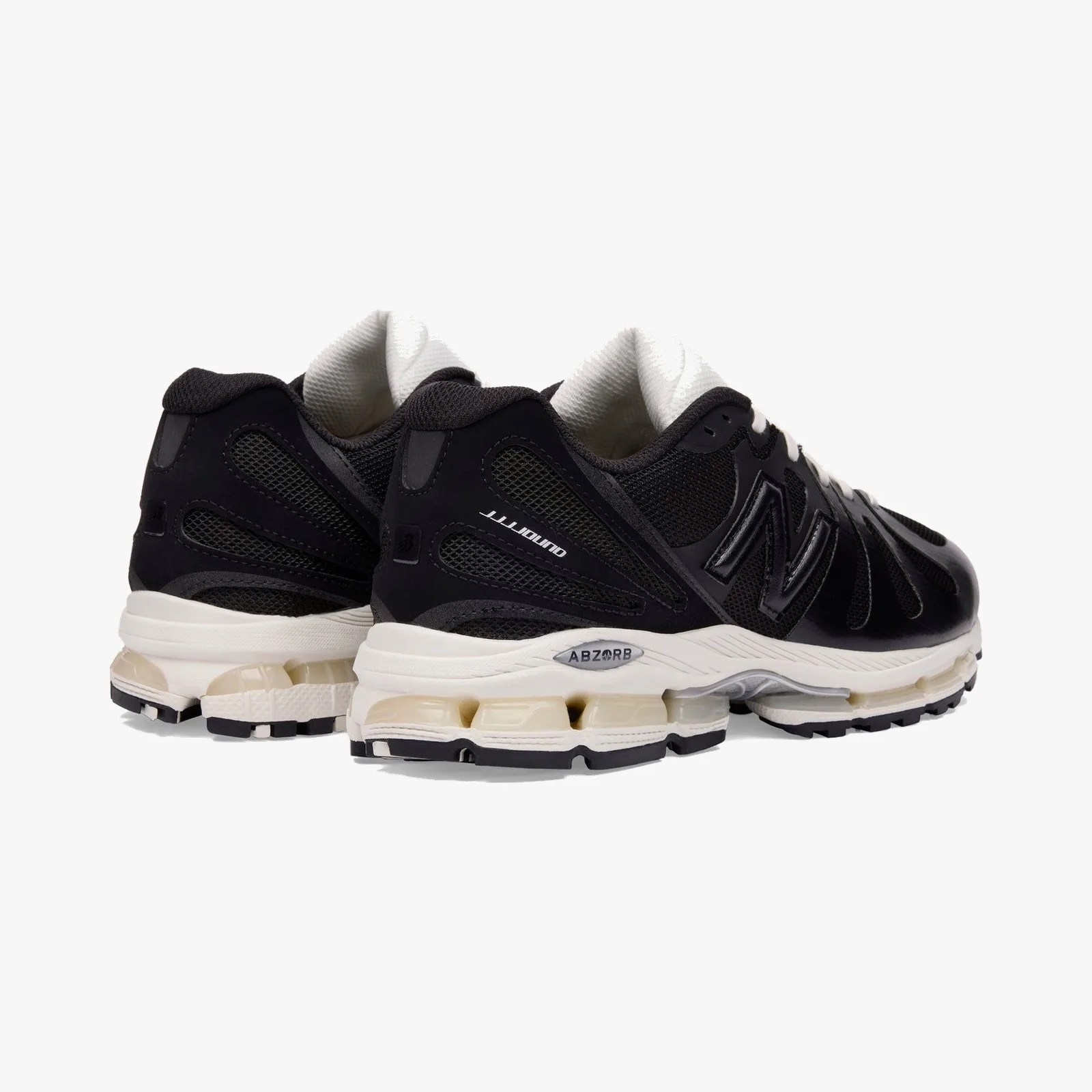 Pair of black New Balance running shoes with white midsoles and ABZORB cushioning visible in the sole.