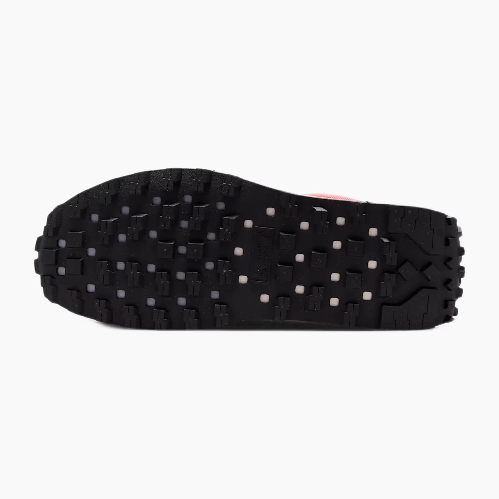 Black rubber shoe sole with square and rectangular tread patterns and small white inserts.