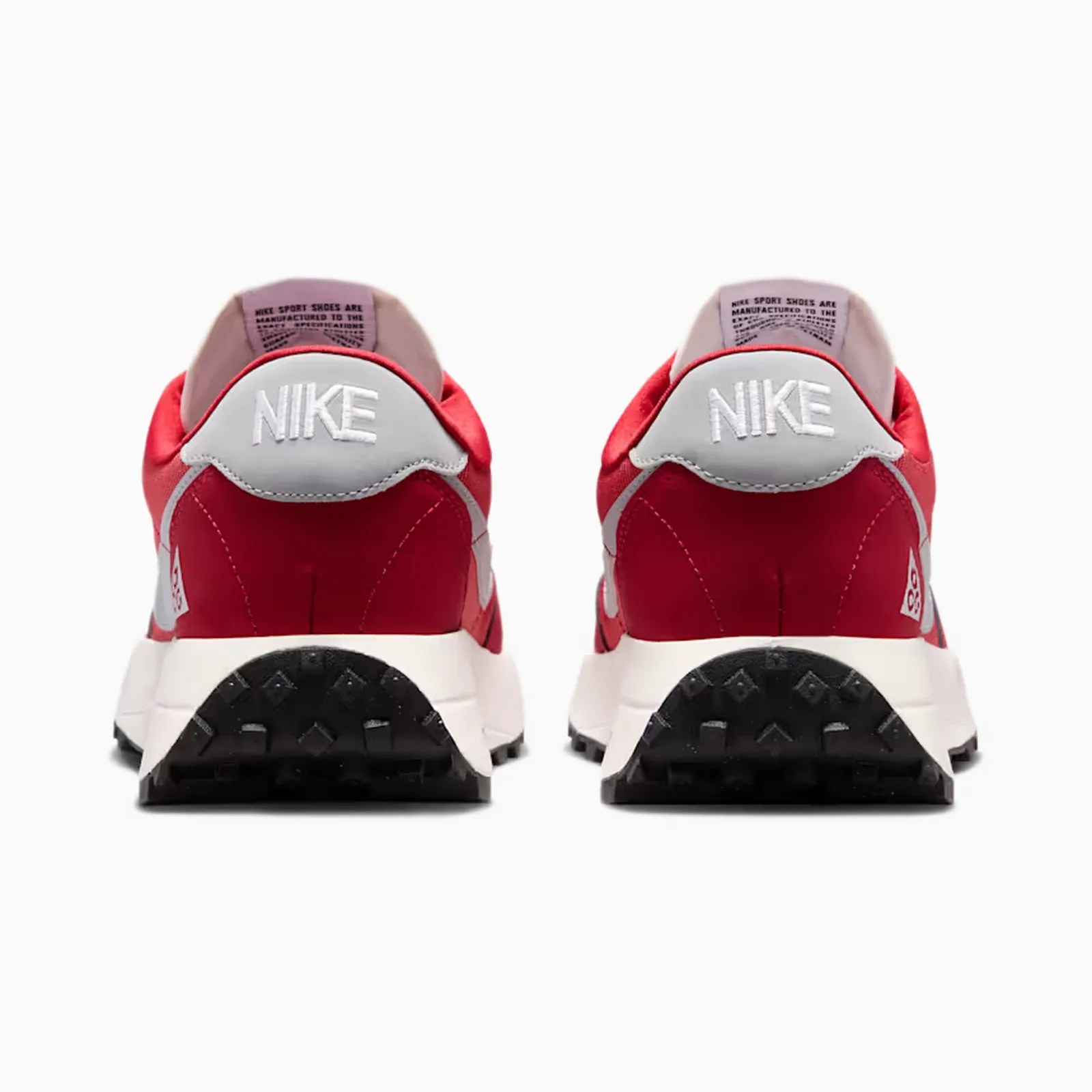 Pair of red and white Nike sneakers shown from the back with black textured soles.