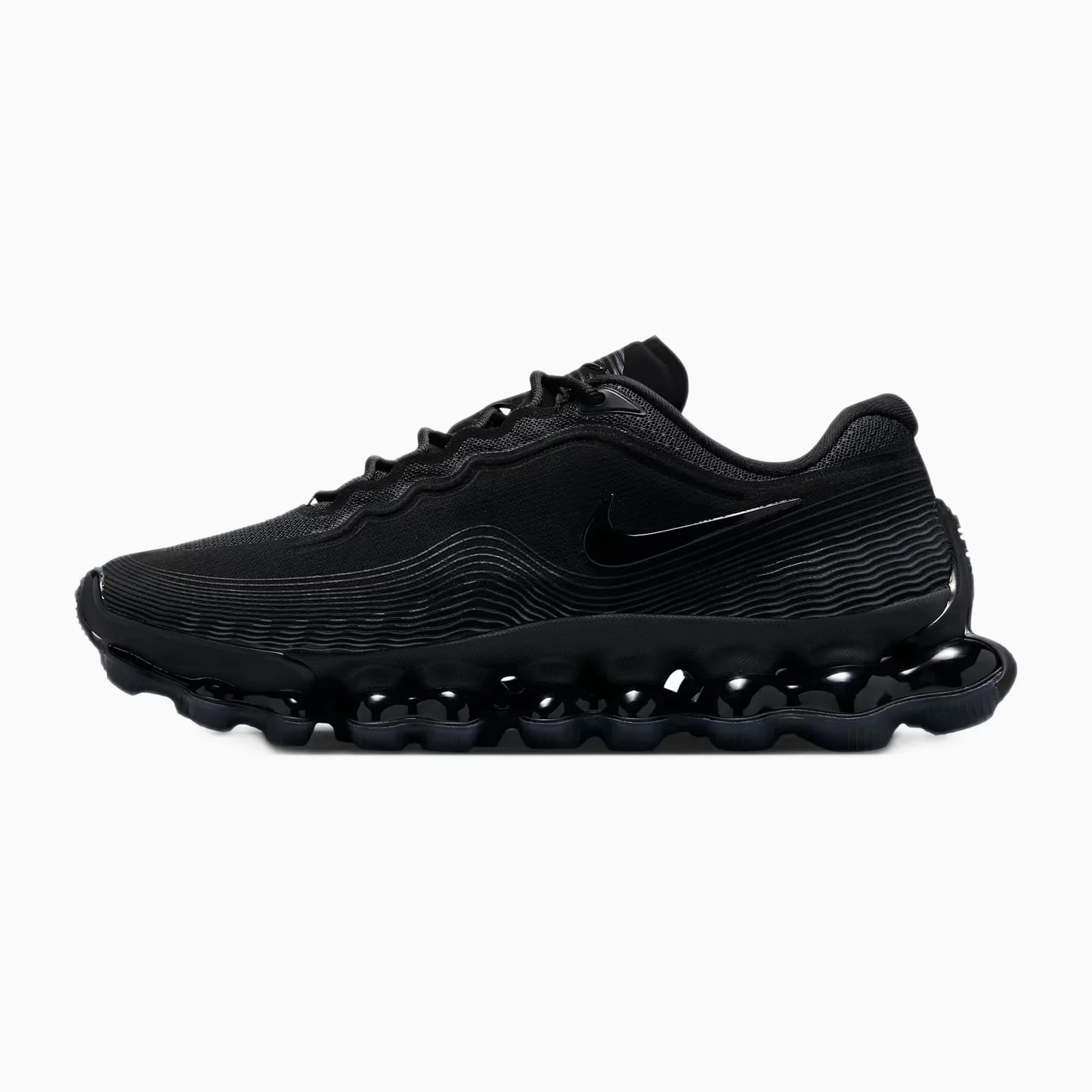 All-black Nike sneaker with textured upper and wavy sole design.