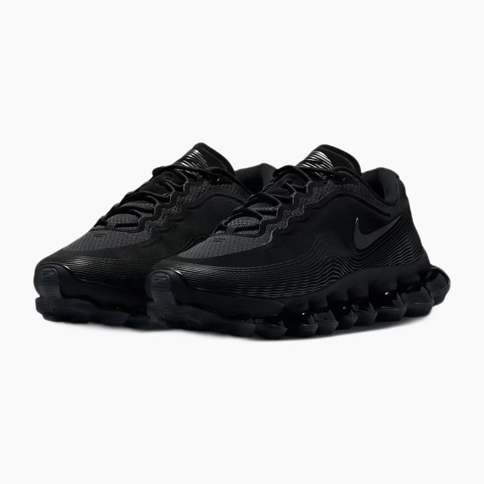 Pair of black Nike running shoes with wavy textured sides and segmented sole.