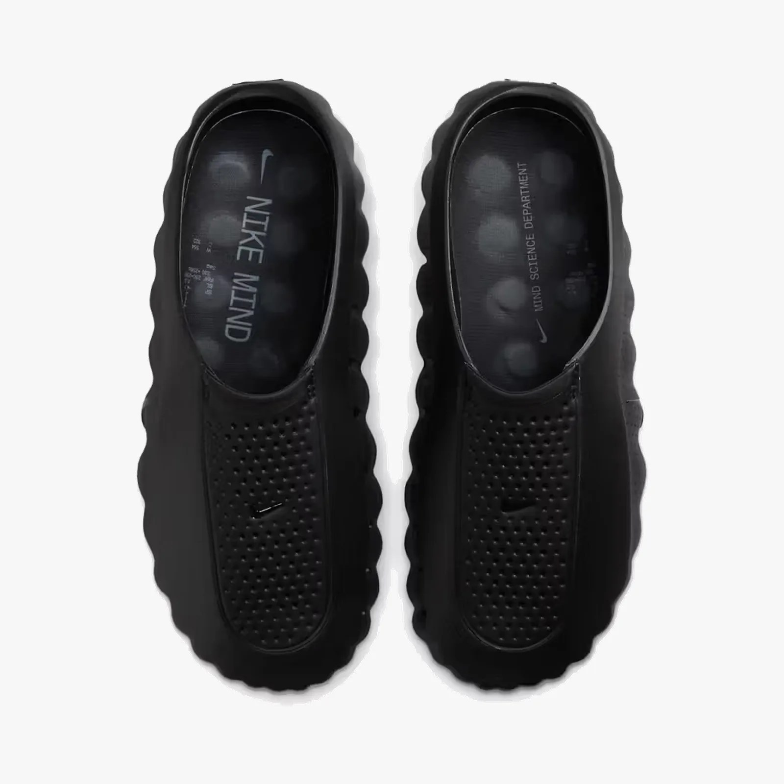 Pair of black Nike slip-on shoes with perforated uppers and "NIKE MIND" and "MIND SCIENCE DEPARTMENT" text inside.