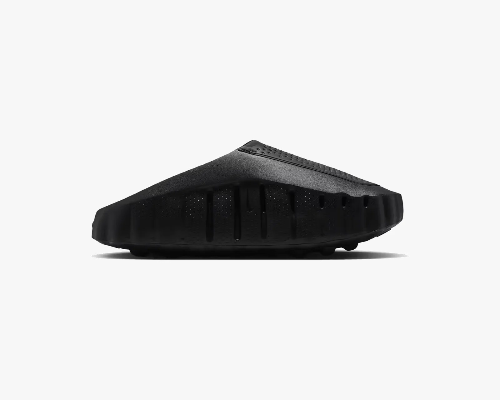 Black slip-on foam shoe with a textured upper and ridged sole, shown from the side on a white background.