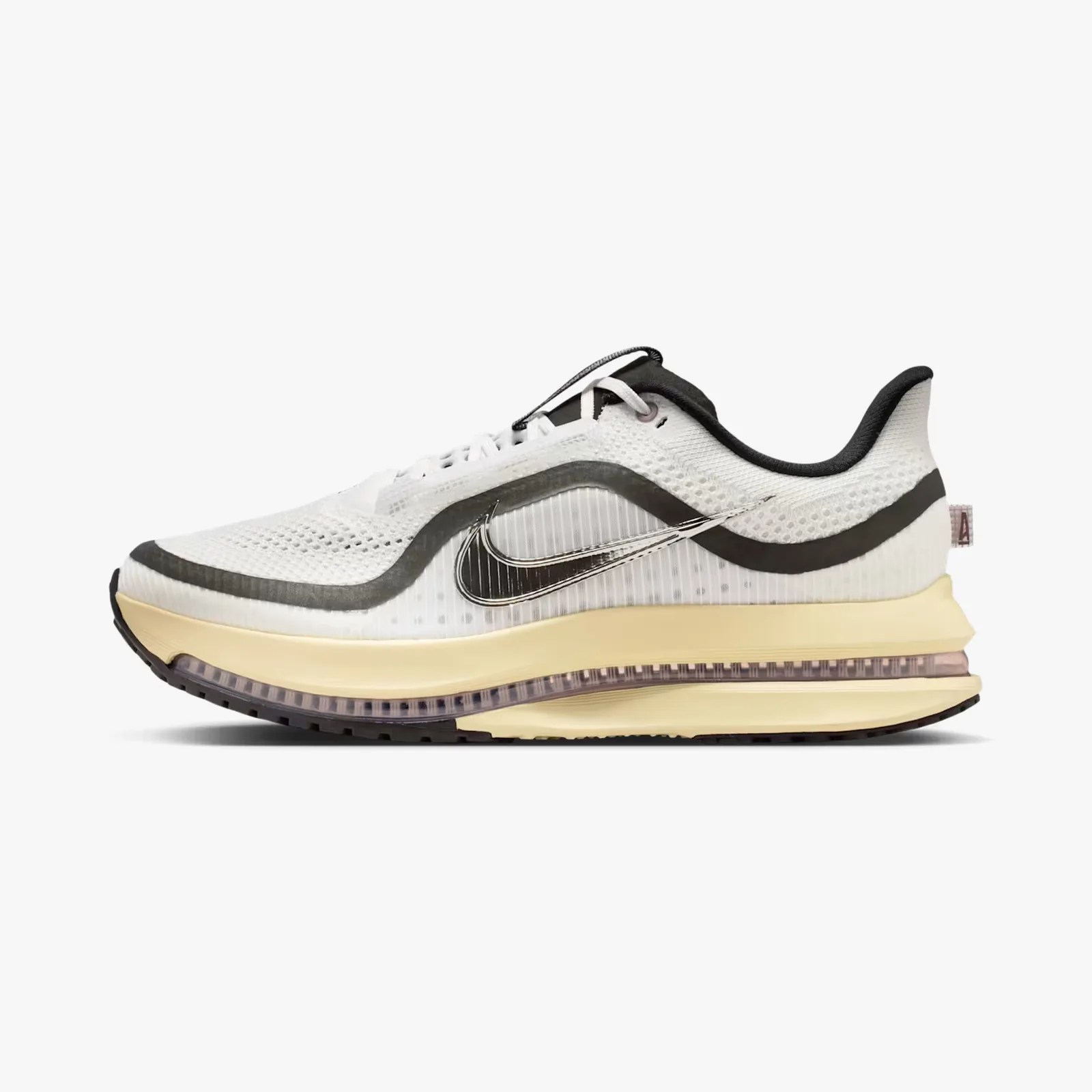 White and black Nike running shoe with beige sole and visible air cushioning.