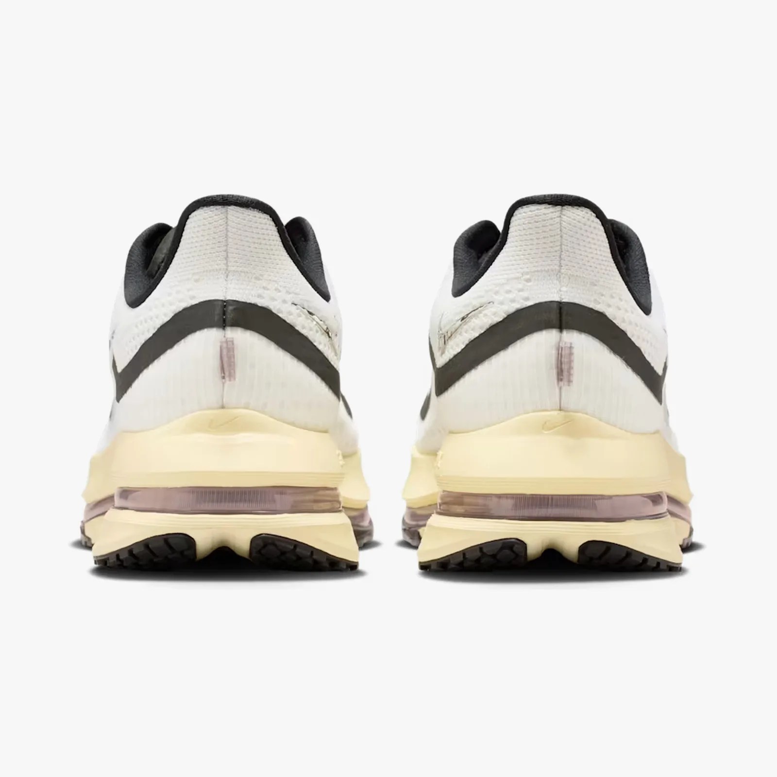 Pair of white and black sneakers with beige midsoles and visible air cushioning, shown from the back.