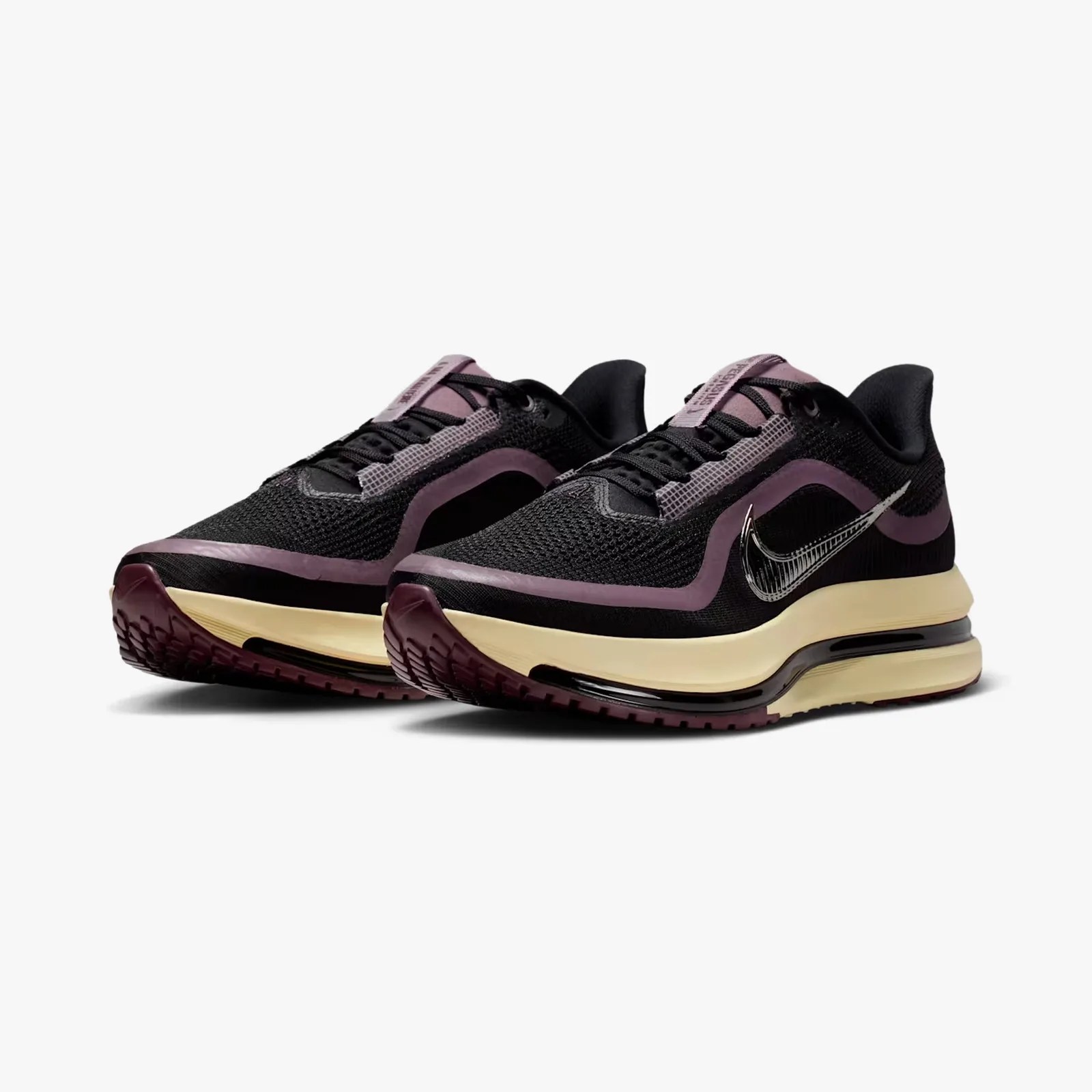 Pair of black and purple Nike running shoes with cream midsoles and visible air cushioning.