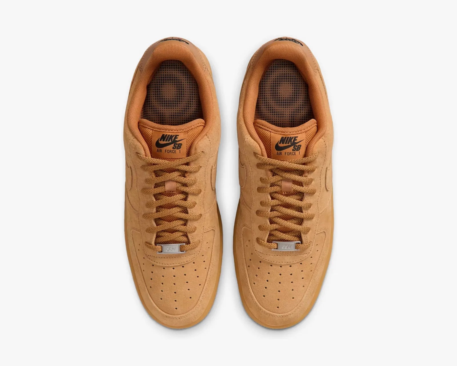 Pair of tan Nike SB Air Force 1 sneakers viewed from above on a white background.